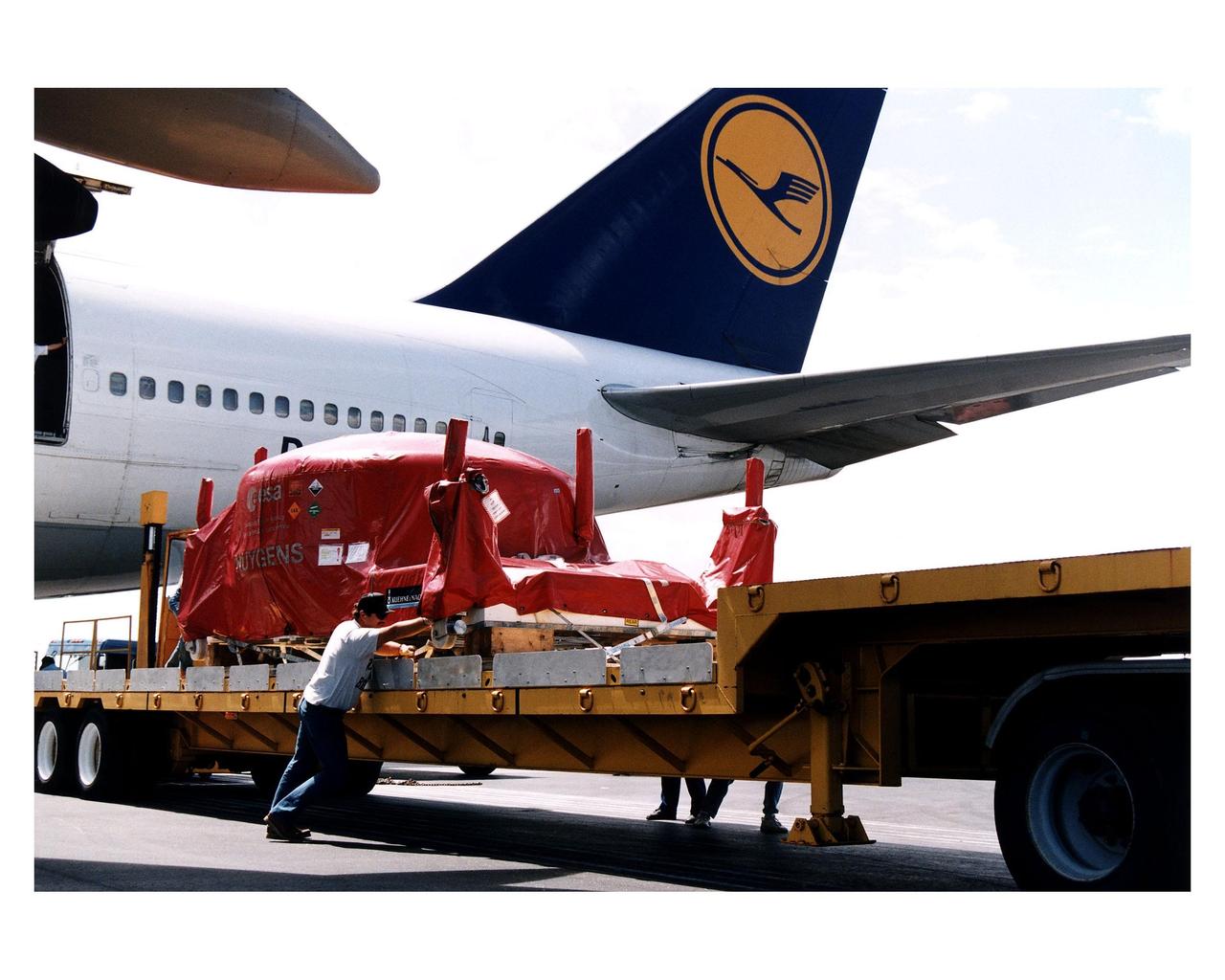 The Huygens probe, which will study the clouds, atmosphere and surface of Saturn's largest moon, Titan, as part of the Cassini mission to Saturn, is prepared for transport from the Skid Strip, Cape Canaveral Air Station (CCAS), after being off-loaded from a plane. The probe was designed and developed for the European Space Agency (ESA) by a European industrial consortium led by Aerospatiale as prime contractor. Over the past year, it was integrated and tested at the facilities of Daimler Benz Aerospace Dornier Satellitensysteme in Germany. The probe will be mated to the Cassini orbiter, which was designed and assembled at NASA's Jet Propulsion Laboratory in California. The Cassini launch is targeted for October 6 from CCAS aboard a Titan IVB/Centaur expendable launch vehicle. After arrival at Saturn in 2004, the probe will be released from the Cassini orbiter to slowly descend through the Titan atmosphere to the moon's surface