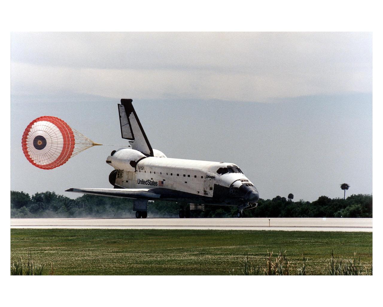 KENNEDY SPACE CENTER, FLA. -- With drag chute deployed, the Space Shuttle Columbia hurtles down Runway 33 at KSCþs Shuttle Landing Facility to conclude the Microgravity Science Laboratory-1 (MSL-1) mission. With main gear touchdown at 2:33:11 p.m. EDT, April 8, the STS-83 mission duration was 3 days, 23 hours, 12 minutes. The planned 16-day mission was cut short by a faulty fuel cell. This is only the third time in Shuttle program history that an orbiter was brought home early due to a mechanical problem. This was also the 36th KSC landing since the program began in 1981. Mission Commander James D. Halsell, Jr. flew Columbia to a perfect landing with help from Pilot Susan L. Still. Other crew members are Payload Commander Janice E. Voss; Mission Specialists Michael L.Gernhardt and Donald A. Thomas; and Payload Specialists Roger K. Crouch and Gregory T. Linteris. In spite of the abbreviated flight, the crew was able to perform MSL-1 experiments. The Spacelab-module-based experiments were used to test some of the hardware, facilities and procedures that are planned for use on the International Space Station and to conduct combustion, protein crystal growth and materials processing investigations
