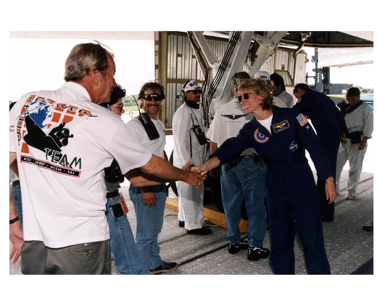 KENNEDY SPACE CENTER, FLA. -- STS-83 Pilot Susan L. Still greets KSC postlanding operations workers on Runway 33 at the Space Center’s Shuttle Landing Facility after the Space Shuttle Orbiter Columbia landed at 2:33:11 p. m. EDT, April 8, to conclude the Microgravity Science Laboratory-1 (MSL-1) mission. At main gear touchdown, the STS-83 mission duration was 3 days, 23 hours, 12 minutes. The planned 16-day mission was cut short by a faulty fuel cell. This is only the third time in Shuttle program history that an orbiter was brought home early due to mechanical problems. This was also the 36th KSC landing since the program began in 1981