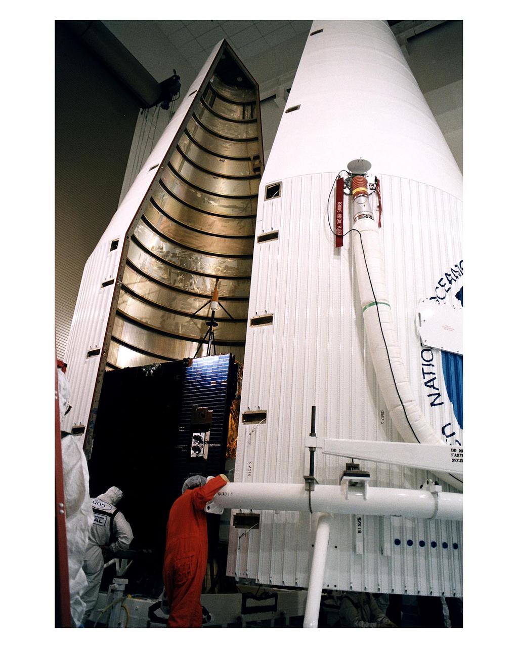 Workers at the Astrotech Space Operations LP facility in Titusville make final checks and adjustments after encapsulating the GOES-K advanced weather satellite in the Atlas 1 payload fairing. GOES-K will be the third spacecraft to be launched in the advanced series of Geostationary Operational Environmental Satellites (GOES). The GOES satellites are owned and operated by the National Oceanic and Atmospheric Administration (NOAA); NASA manages the design, development and launch of the spacecraft. GOES-K is targeted for an <a href="http://www-pao.ksc.nasa.gov/kscpao/release/1997/63-97.htm">April 24 launch</a> aboard a Lockheed Martin Atlas 1 expendable launch vehicle (AC-79) from Launch Complex 36, Pad B, Cape Canaveral Air Station. The launch window opens at 1:50 a.m. and extends to 3:09 a.m. EDT. Once in orbit, GOES-K will become GOES-10, joining GOES-8 and GOES-9 in space