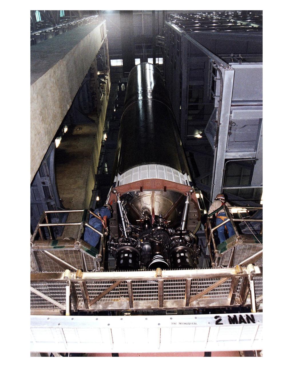 The first stage of the Titan IV expendable launch vehicle that will propel the Cassini spacecraft to Saturn and its moon Titan is lowered into a high bay in the Vertical Integration Building at Cape Canaveral Air Station (CCAS) to begin stacking operations. The Titan IV is currently scheduled to lift off from Launch Pad 40 at CCAS on October 6. Once deployed from the Titan's Centaur upper stage, Cassini will conduct gravity-assist flybys of the planets Venus and Jupiter, then arrive at Saturn in July 2004. Once there, it will perform an orbital survey of Saturn and send the European Space Agency's Huygens Probe into the dense and seemingly Earthlike atmosphere of Titan. The Cassini project is managed by NASA's Jet Propulsion Laboratory (JPL), Pasadena, California