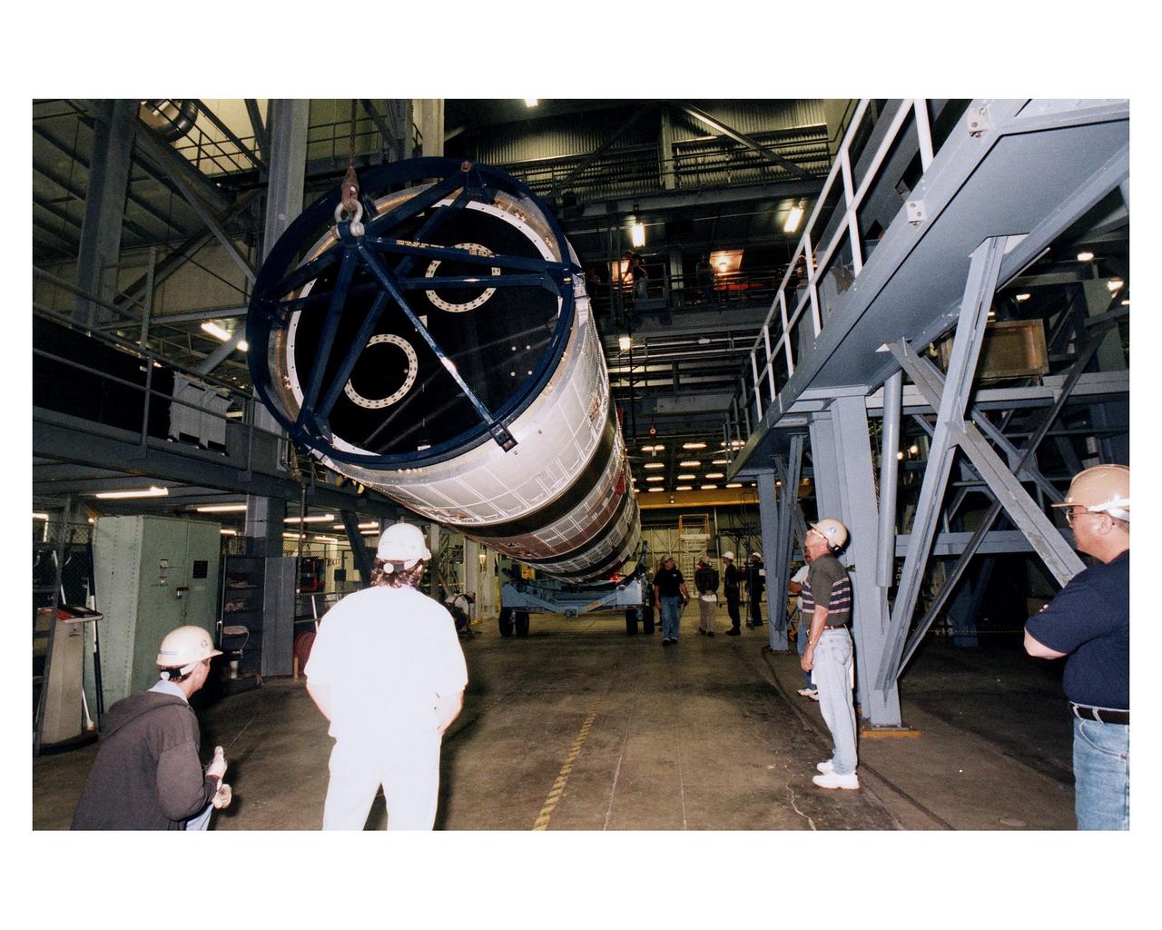 Lockheed Martin technicians and engineers in the Vertical Integration Building prepare to hoist the second stage of a Titan IV/Centaur expendable launch vehicle into a vertical position where it can lifted and mated to the first stage of the rocket. The Titan IVB rocket is the newest version of America's most powerful unmanned rocket. This rocket will be used for the Cassini mission to Saturn. The Cassini launch is targeted for October 6 from Launch Complex 40, Cape Canaveral Air Station