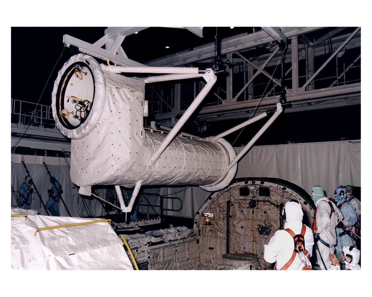 The Spacelab long transfer tunnel that leads from the Space Shuttle Orbiter Columbia’s crew airlock to the Microgravity Science Laboratory-1 (MSL-1) Spacelab module in the spaceplane’s payload bay is removed in Orbiter Processing Facility 1. The tunnel was taken out to allow better access to the MSL-1 module during reservicing operations to prepare it for its reflight as MSL-1R. That mission is now scheduled to lift off July 1. This was the first time that this type of payload was reserviced without removing it from the payload bay. This new procedure pioneers processing efforts for quick relaunch turnaround times for future payloads. The Spacelab module was scheduled to fly again with the full complement of STS-83 experiments after that mission was cut short due to a faulty fuel cell. During the scheduled 16-day reflight, the experiments will be used to test some of the hardware, facilities and procedures that are planned for use on the International Space Station while the flight crew conducts combustion, protein crystal growth and materials processing experiments