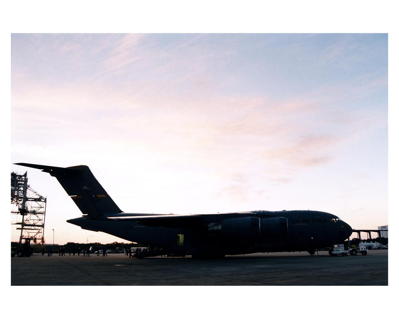 Workers begin unloading the Cassini orbiter from a U.S. Air Force C-17 air cargo plane after its <a href="http://www-pao.ksc.nasa.gov/kscpao/release/1997/66-97.htm">arrival</a> at KSC’s Shuttle Landing Facility from Edwards Air Force Base, California. The orbiter and the Huygens probe already being processed at KSC are the two primary components of the Cassini spacecraft, which will be launched on a Titan IVB/Centaur expendable launch vehicle from Cape Canaveral Air Station. Cassini will explore Saturn, its rings and moons for four years. The Huygens probe, designed and developed for the European Space Agency (ESA), will be deployed from the orbiter to study the clouds, atmosphere and surface of Saturn’s largest moon, Titan. The orbiter was designed and assembled at NASA’s Jet Propulsion Laboratory in California. Following postflight inspections, integration of the 12 science instruments not already installed on the orbiter will be completed. Then, the parabolic high-gain antenna and the propulsion module will be mated to the orbiter, followed by the Huygens probe, which will complete spacecraft integration. The Cassini mission is targeted for an Oct. 6 launch to begin its 6.7-year journey to the Saturnian system. Arrival at the planet is expected to occur around July 1, 2004