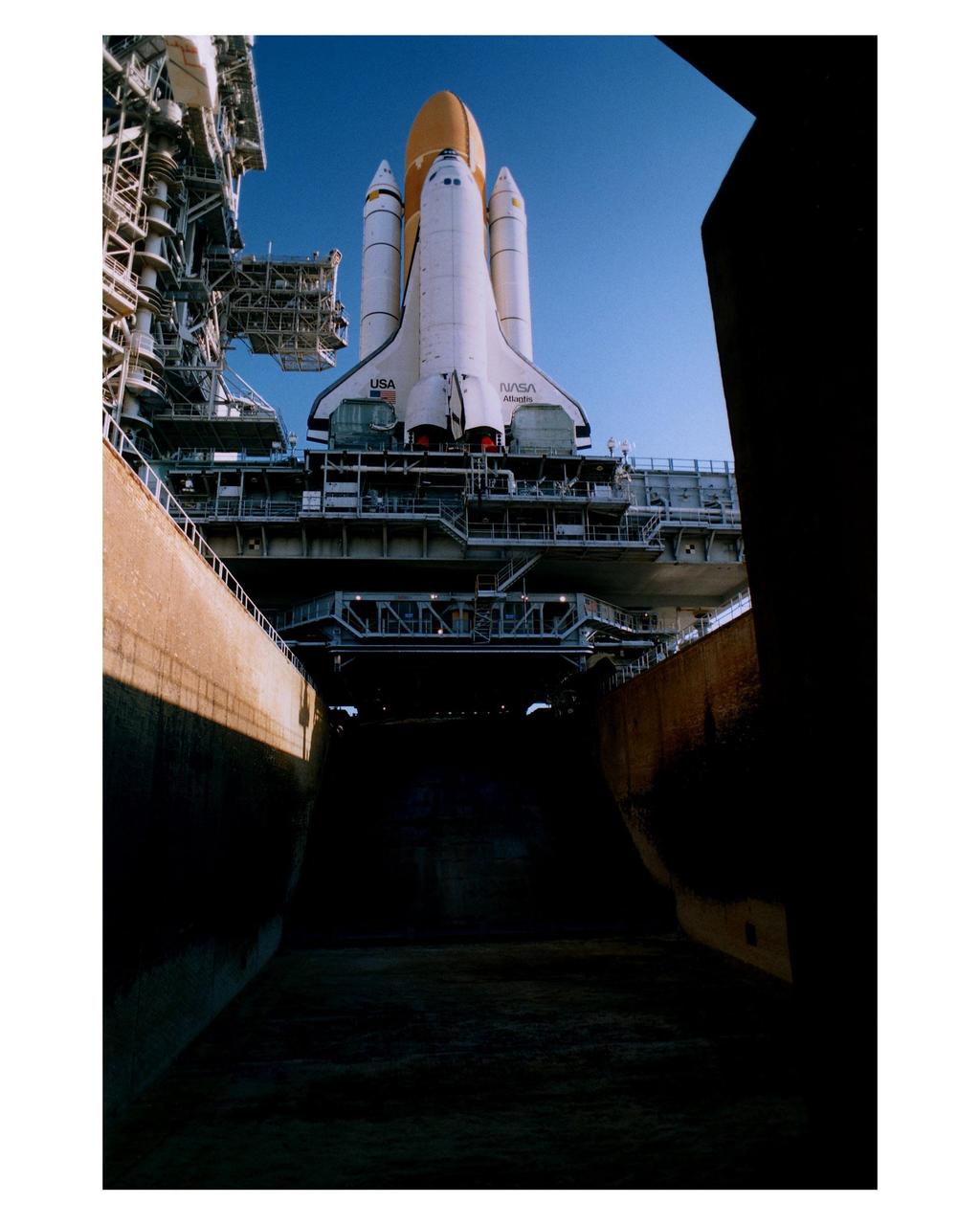KENNEDY SPACE CENTER, Fla. -- The Space Shuttle Atlantis sits majestically atop its Mobile Launcher Platform and a Crawler-Transporter which straddle the Launch Pad 39A flame trench. This view shows only a portion of the flame trench, which is about 450 feet long, 58 feet wide and 42 feet deep. The Shuttle has just arrived at the launch pad after the journey from the Vehicle Assembly Building. Atlantis and its crew of seven are targeted for a May 15 launch. STS-84 will be the sixth Shuttle docking with the Russian Space Station Mir as part of Phase 1 of the International Space Station program