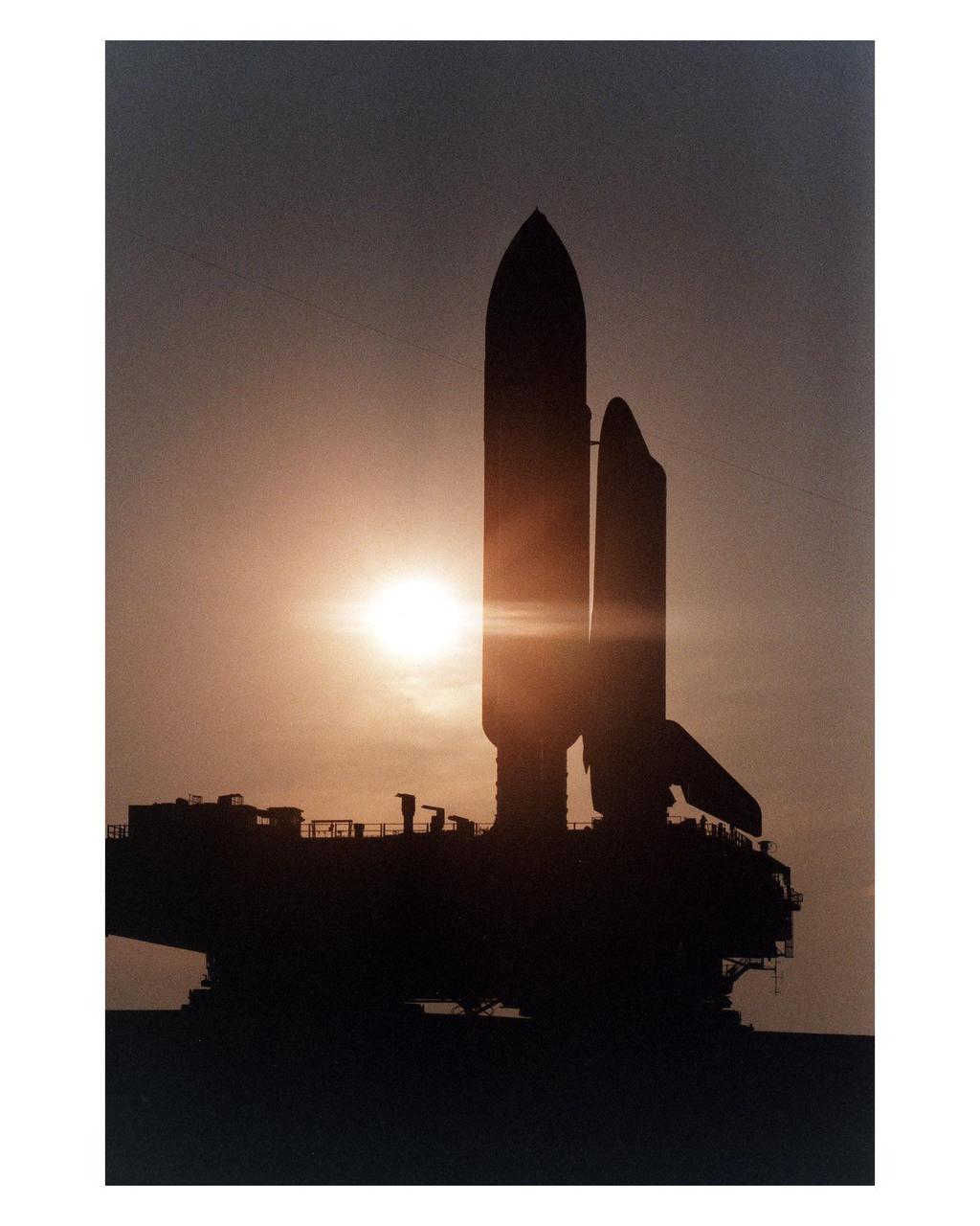 KENNEDY SPACE CENTER, Fla. --  Cast in silhouette by the rising sun, the Space Shuttle Atlantis slowly and carefully makes the journey along the Crawlerway between the Vehicle Assembly Building and Launch Pad 39A. Atlantis and its crew of seven are targeted for a May 15 launch. STS-84 will be the sixth Shuttle docking with the Russian Space Station Mir as part of Phase 1 of the International Space Station program