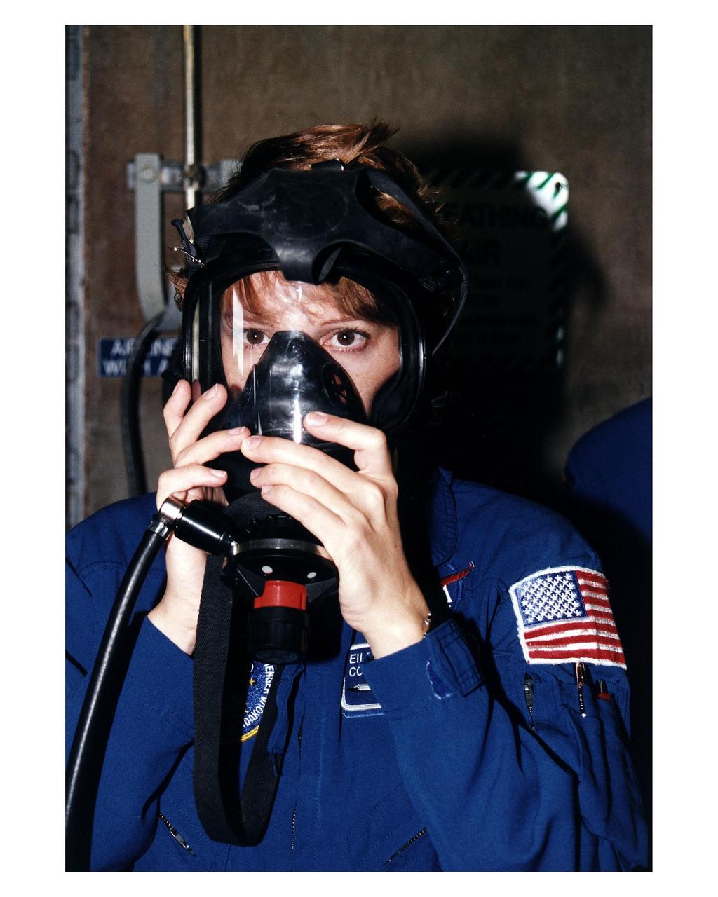 STS-84 Pilot Eileen Marie Collins practices using a gas mask during Terminal Countdown Demonstration Test (TCDT) activities at Launch Pad 39A. STS-84 will be the sixth docking of the Space Shuttle with the Russian Space Station Mir. It will be second space flight for Collins, who was the first woman Shuttle pilot on her initial mission, STS-63 in 1995. After docking, STS-84 Mission Specialist C. Michael Foale will transfer to the space station and become a member of the Mir 23 crew, replacing U.S. astronaut Jerry M. Linenger, who will return to Earth aboard Atlantis. Foale will live and work on Mir until mid-September when his replacement is expected to arrive on the STS-86 mission. STS-84 is targeted for a May 15 liftoff