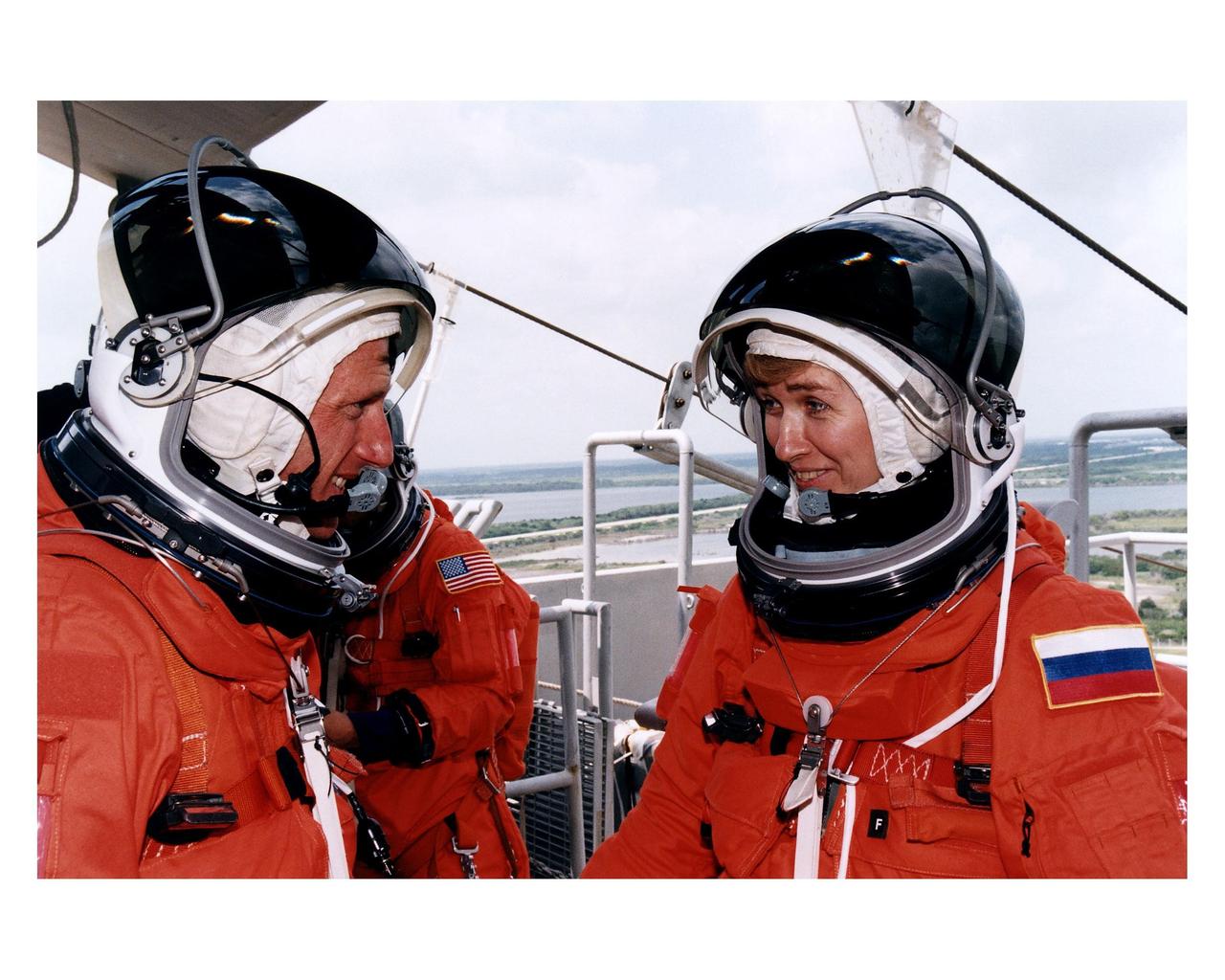 STS-84 Mission Specialists C. Michael Foale, at left, and Elena V. Kondakova, of the Russian Space Agency, find a moment to communicate one-on-one, perhaps about upcoming and past experiences living on the Russian Space Station Mir, during a busy training session at Launch Pad 39A. They and the other five crew members are participating in the Terminal Countdown Demonstration Test (TCDT), a dress rehearsal for launch. STS-84 aboard Atlantis will be the sixth docking of the Space Shuttle with the Mir. Kondakova spent 169 days in space as the cosmonaut flight engineer of the 17th main mission to Mir from Oct. 4, 1994, to March 9, 1995. After Atlantis docks with Mir on STS-84, Foale will transfer to the space station and become a member of the Mir 23 crew, replacing U.S. astronaut Jerry M. Linenger, who will return to Earth aboard Atlantis. Foale will live and work on Mir until mid-September when his replacement is expected to arrive on the STS-86 mission. STS-84 is targeted for a May 15 liftoff.