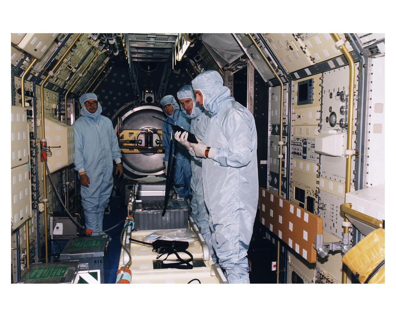 KENNEDY SPACE CENTER, FLA. -- KSC payloads processing employees work to reservice the Microgravity Science Laboratory-1 (MSL-1) Spacelab module in the Space Shuttle Orbiter Columbia’s payload bay for the STS-94 mission in Orbiter Processing Facility 1. That mission is now scheduled to lift off in early July. This was the first time that this type of payload was reserviced without removing it from the payload bay. This new procedure pioneers processing efforts for quick relaunch turnaround times for future payloads. The Spacelab module was scheduled to fly again with the full complement of STS-83 experiments after that mission was cut short due to a faulty fuel cell. During the scheduled 16-day STS-94 mission, the experiments will be used to test some of the hardware, facilities and procedures that are planned for use on the International Space Station while the flight crew conducts combustion, protein crystal growth and materials processing experiments