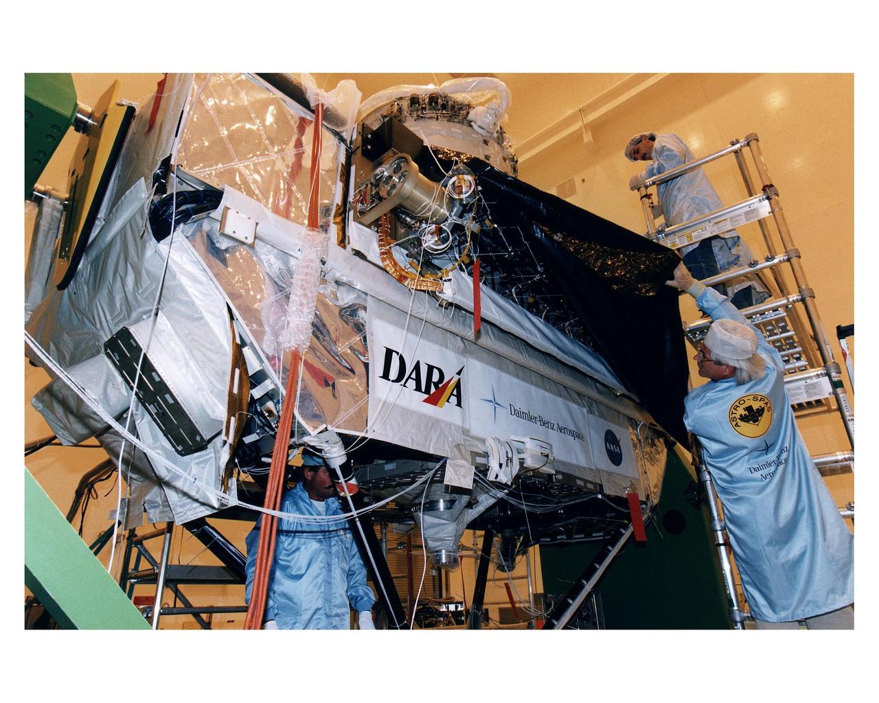 Employees of Daimler-Benz Aerospace in the Multi-Payload Processing Facility install insulation on the Cryogenic Infrared Spectro-meters and Telescopes for the Atmosphere-Shuttle Pallet Satellite-2 (CRISTA-SPAS-2) payload for the STS-85 mission. The CRISTA is a system of three telescopes and four spectrometers to measure infrared radiation emitted by the Earth’s middle atmosphere. During the 11- day mission, the CRISTA-SPAS-2 free-flying satellite will be deployed from the Space Shuttle Discovery and retrieved later in the flight. Also onboard the satellite will be the Middle Atmosphere High Resolution Spectrograph Investigation (MAHRSI) to measure ultraviolet radiation emitted and scattered by the Earth’s atmosphere