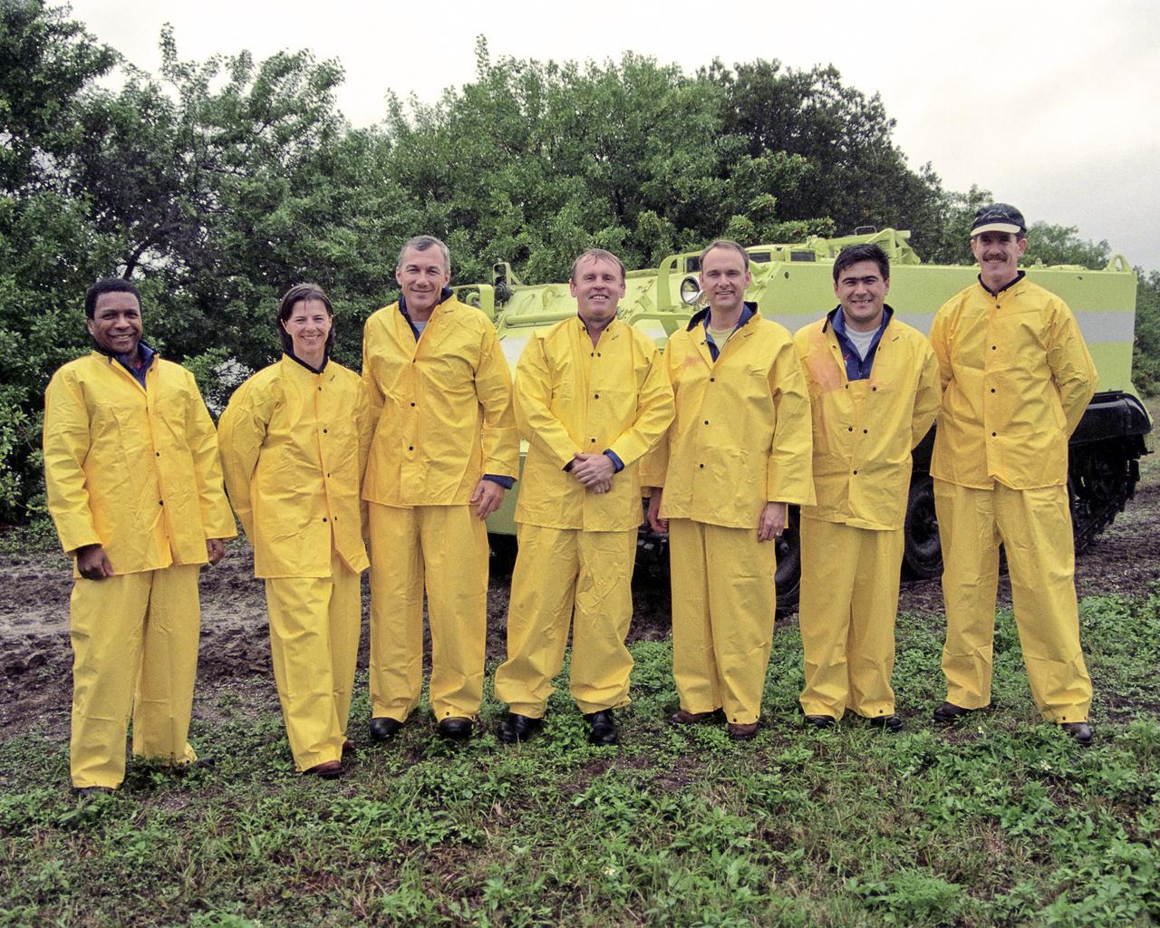 CAPE CANAVERAL, Fla. --The STS-89 crew pose in front of an M-113 armored personnel carrier while participating in Terminal Countdown Demonstration Test TCDT activities.  The TCDT is held at KSC prior to each Space Shuttle flight to provide crews with an opportunity to participate in simulated countdown activities.  Posing, from left to right, are Mission Specialists Michael Anderson and Bonnie Dunbar, Ph.D. Commander Terrence Wilcutt Mission Specialist Andrew Thomas, Ph.D. Pilot Joe Edwards, Jr. and Mission Specialists Salizhan Sharipov of the Russian Space Agency and James Reilly, Ph.D.  The STS-89 mission will be the eighth docking of the Space Shuttle with the Russian Space Station Mir.  After docking, Dr. Thomas will transfer to the space station, succeeding David Wolf, M.D., who will return to Earth aboard Endeavour.  Dr. Thomas will live and work on Mir until June.  STS-89 is scheduled for a January 22 liftoff at 9:48 p.m.    Photo credit: NASA