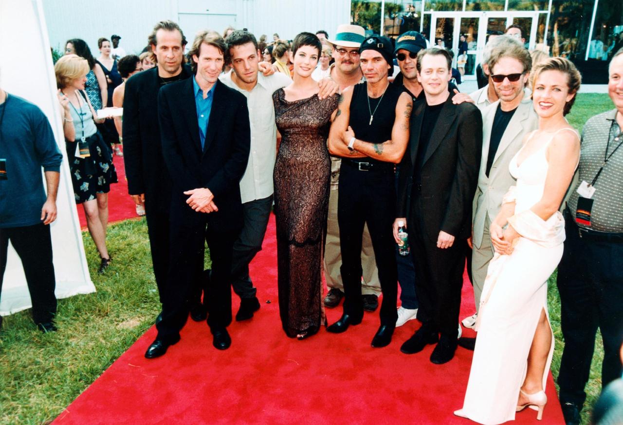 KENNEDY SPACE CENTER, FLA. --  Posing in front of the world premiere release of the film "Armageddon" are Peter Stormare, director Michael Bay, Ben Affleck, Liv Tyler, Ken Campbell, Billy Bob Thornton, Bruce Willis, Steve Buscemi, producer Jerry Bruckheimer and Jessica Steen.  The screening was held in a theater specially constructed at the Apollo/Saturn V Center at the Kennedy Space Center.  The movie was partly filmed at KSC, and as part of the premiere festivities, guests had a chance to see many of the sites actually used in the film as well as explore a wide range of NASA artifacts and displays.  A private party that included a performance by rock band Aerosmith followed the premiere.                            