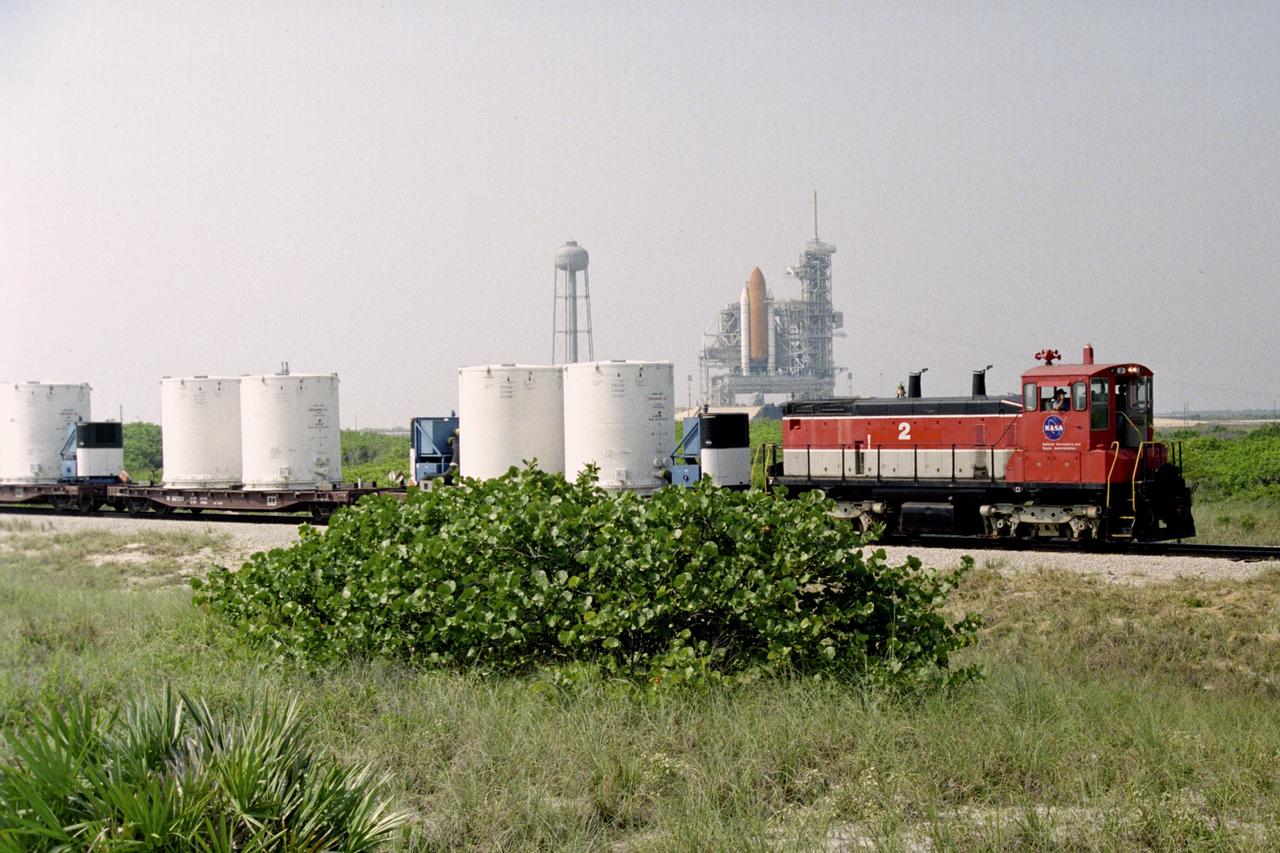 CAPE CANAVERAL, Fla. – A NASA railroad train moves past Launch Pad 39A at NASA's Kennedy Space Center in Florida. The space agency utilizes railroad operations to not only move equipment at Kennedy, but to transport hardware to and from contractor facilities across the nation. Photo credit: NASA