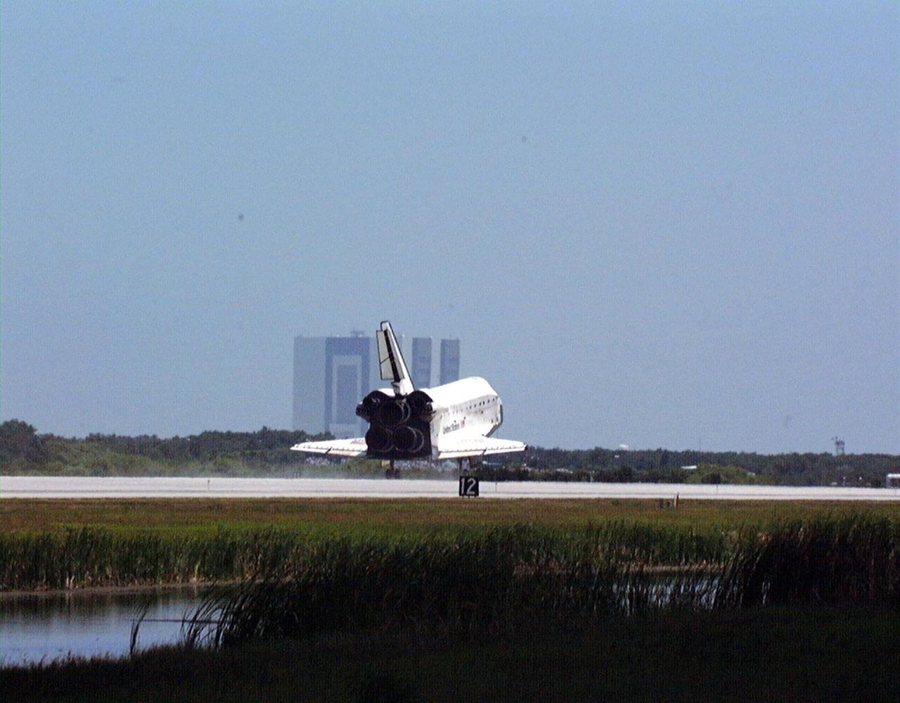 KENNEDY SPACE CENTER, FLA. -- With the 525-foot-tall Vehicle Assemble Building as backdrop, the orbiter Discovery touches down on Runway 15 of KSC's Shuttle Landing Facility to complete the STS-91 mission. Main gear touchdown was at 2:00:18 p.m. EDT on June 12, 1998, landing on orbit 155 of the mission. The wheels stopped at 2:01:22 p.m. EDT, for a total mission-elapsed time of 9 days, 19 hours, 55 minutes and 1 second. The 91st Shuttle mission was the 44th KSC landing in the history of the Space Shuttle program and the 15th consecutive landing at KSC. During the mission, the orbiter docked with the Russian space station Mir for the ninth time, concluding Phase I of the joint U.S.-Russian International Space Station Program. STS-91 also featured first flights for both the Alpha Magnetic Spectrometer and the Space Shuttle super lightweight external tank. The STS-91 flight crew included Mission Commander Charles J. Precourt; Pilot Dominic L. Gorie; and Mission Specialists Wendy B. Lawrence, Franklin R. Chang-Diaz, Janet Lynn Kavandi and Valery Victorovitch Ryumin of the Russian Space Agency. Astronaut Andrew S. W. Thomas also returned to Earth from Mir as an STS-91 crew member after 141 days in space