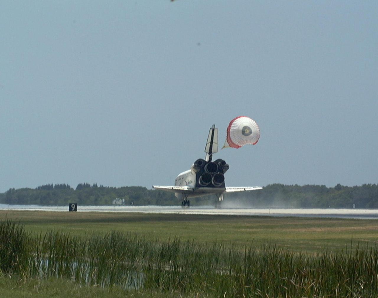 KENNEDY SPACE CENTER, FLA. -- With its drag chute deployed, the orbiter Discovery touches down on Runway 15 of KSC's Shuttle Landing Facility to complete the STS-91 mission. Main gear touchdown was at 2:00:18 p.m. EDT on June 12, 1998, landing on orbit 155 of the mission. The wheels stopped at 2:01:22 p.m. EDT, for a total mission-elapsed time of 9 days, 19 hours, 55 minutes and 1 second. The 91st Shuttle mission was the 44th KSC landing in the history of the Space Shuttle program and the 15th consecutive landing at KSC. During the mission, the orbiter docked with the Russian space station Mir for the ninth time, concluding Phase I of the joint U.S.-Russian International Space Station Program. STS-91 also featured first flights for both the Alpha Magnetic Spectrometer and the Space Shuttle super lightweight external tank. The STS-91 flight crew included Mission Commander Charles J. Precourt; Pilot Dominic L. Gorie; and Mission Specialists Wendy B. Lawrence, Franklin R. Chang-Diaz, Janet Lynn Kavandi and Valery Victorovitch Ryumin of the Russian Space Agency. Astronaut Andrew S. W. Thomas also returned to Earth from Mir as an STS-91 crew member after 141 days in space