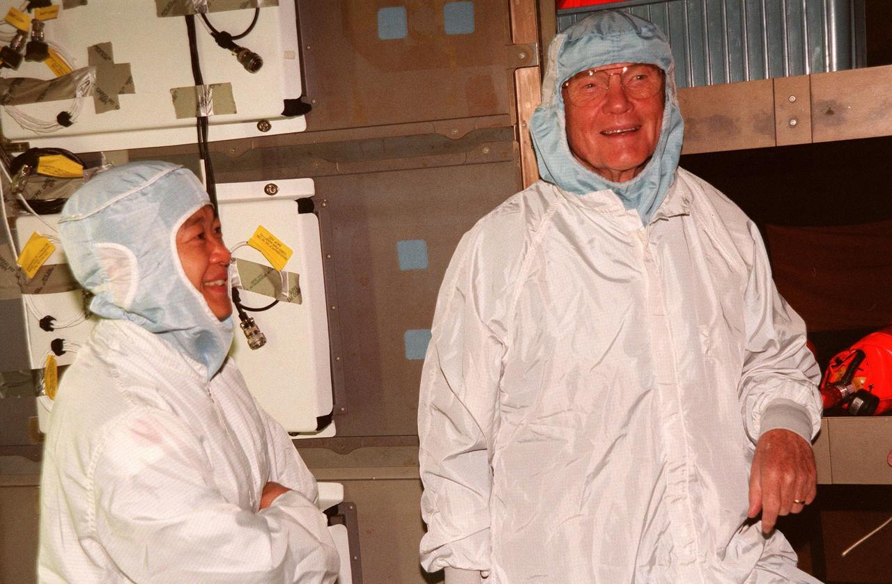 (Left to right) STS-95 Payload Specialists Chiaki Mukai, with the National Space Development Agency of Japan, and John H. Glenn Jr., senator from Ohio, take part in middeck orientation during a Crew Equipment Interface Test (CEIT) in the Orbiter Processing Facility Bay 2. The CEIT gives astronauts an opportunity for a hands-on look at the payloads on which they will be working on orbit. The launch of the STS-95 mission, aboard Space Shuttle Discovery, is scheduled for Oct. 29, 1998. The mission includes research payloads such as the Spartan solar-observing deployable spacecraft, the Hubble Space Telescope Orbital Systems Test Platform, the International Extreme Ultraviolet Hitchhiker, as well as the SPACEHAB single module with experiments on space flight and the aging process