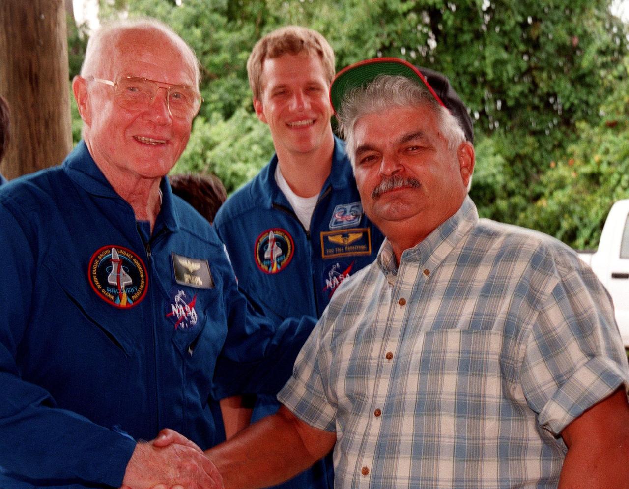 During a break in the Crew Equipment Interface Test (CEIT), Payload Specialist John H. Glenn Jr.(left), a senator from Ohio, greets Bobby Miranda. Miranda was a NASA photographer for Glenn's first flight on Friendship 7, February 1962. In the background is Mission Specialist Scott E. Parazynski. The CEIT gives astronauts an opportunity for a hands-on look at the payloads and equipment with which they will be working on orbit. The launch of the STS-95 mission is scheduled for Oct. 29, 1998, on the Space Shuttle Discovery. The mission includes research payloads such as the Spartan solar-observing deployable spacecraft, the Hubble Space Telescope Orbital Systems Test Platform, the International Extreme Ultraviolet Hitchhiker, as well as the SPACEHAB single module with experiments on space flight and the aging process