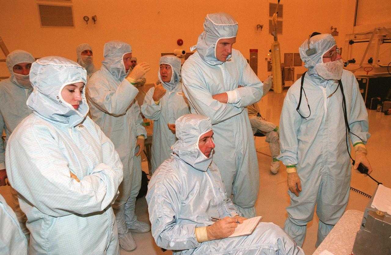 During Crew Equipment Interface Test (CEIT), STS-95 Mission Specialists Stephen K. Robinson (seated), and Scott E. Parazynski (standing behind him) look at a monitor displaying the Spartan payload that will be part of the mission. In the background (center) are Pilot Steven W. Lindsey and Payload Specialist Chiaki Mukai, with the National Space Development Agency of Japan (NASDA). Technicians are gathered around them. The CEIT gives astronauts an opportunity for a hands-on look at the payloads and equipment with which they will be working on orbit. The launch of the STS-95 mission is scheduled for Oct. 29, 1998. The mission includes research payloads such as the Spartan solar-observing deployable spacecraft, the Hubble Space Telescope Orbital Systems Test Platform, the International Extreme Ultraviolet Hitchhiker, as well as the SPACEHAB single module with experiments on space flight and the aging process