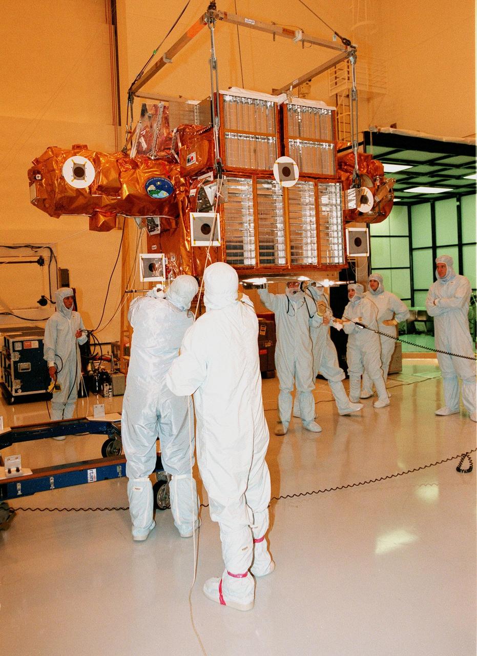 During Crew Equipment Interface Test (CEIT), STS-95 crew members watch as workers move the Spartan payload inside the Multi-Payload Processing Facility. At far right is Mission Specialist Scott E. Parazynski. The CEIT gives astronauts an opportunity for a hands-on look at the payloads and equipment with which they will be working on orbit. The launch of the STS-95 mission is scheduled for Oct. 29, 1998. The mission includes research payloads such as the Spartan solar-observing deployable spacecraft, the Hubble Space Telescope Orbital Systems Test Platform, the International Extreme Ultraviolet Hitchhiker, as well as the SPACEHAB single module with experiments on space flight and the aging process