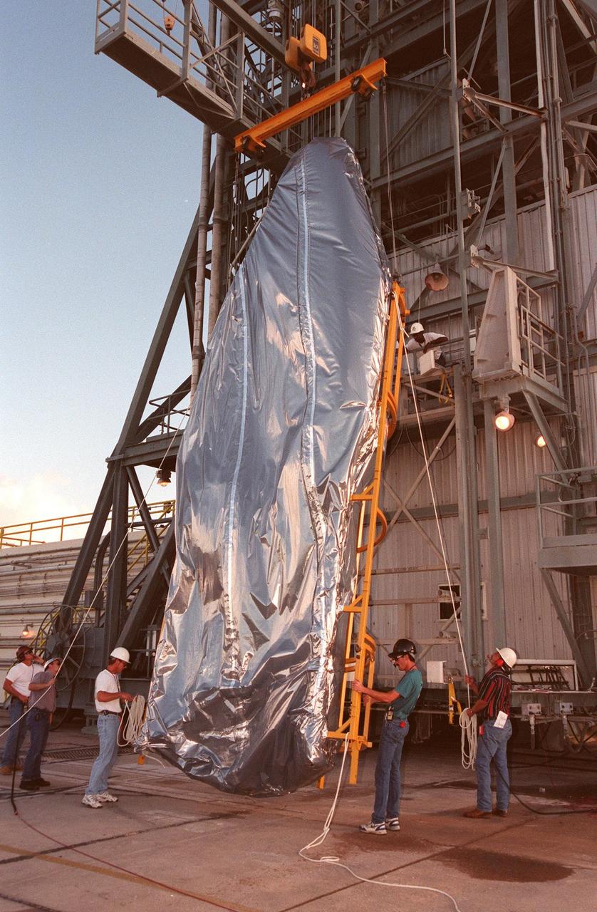 KENNEDY SPACE CENTER, FLA. -- The fairing for Deep Space 1 is raised upright before being lifted on the Mobile Service Tower to its place on the Boeing Delta 7326 rocket that will launch on Oct. 15, 1998. The first flight in NASA's New Millennium Program, Deep Space 1 is designed to validate 12 new technologies for scientific space missions of the next century. Onboard experiments include an ion propulsion engine and software that tracks celestial bodies so the spacecraft can make its own navigation decisions without the intervention of ground controllers. Deep Space 1 will complete most of its mission objectives within the first two months, but will also do a flyby of a near-Earth asteroid, 1992 KD, in July 1999