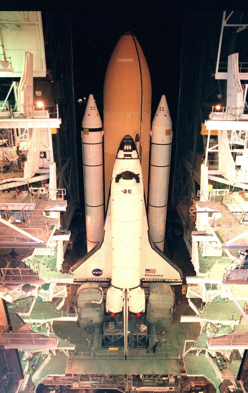 In the pre-dawn hours, STS-95 Space Shuttle Discovery, on the Mobile Launch Platform, exits the doors of the Vehicle Assembly Building as it begins rollout to Launch Complex Pad 39B via the crawler transporter. The 4.2-mile trip takes approximately 6 hours. Once at the launch pad, the orbiter, external tank and solid rocket boosters will undergo final preparations for the launch, scheduled to lift off Oct. 29. The mission includes research payloads such as the Spartan solar-observing deployable spacecraft, the Hubble Space Telescope Orbital Systems Test Platform, the International Extreme Ultraviolet Hitchhiker, as well as the SPACEHAB single module with experiments on space flight and the aging process