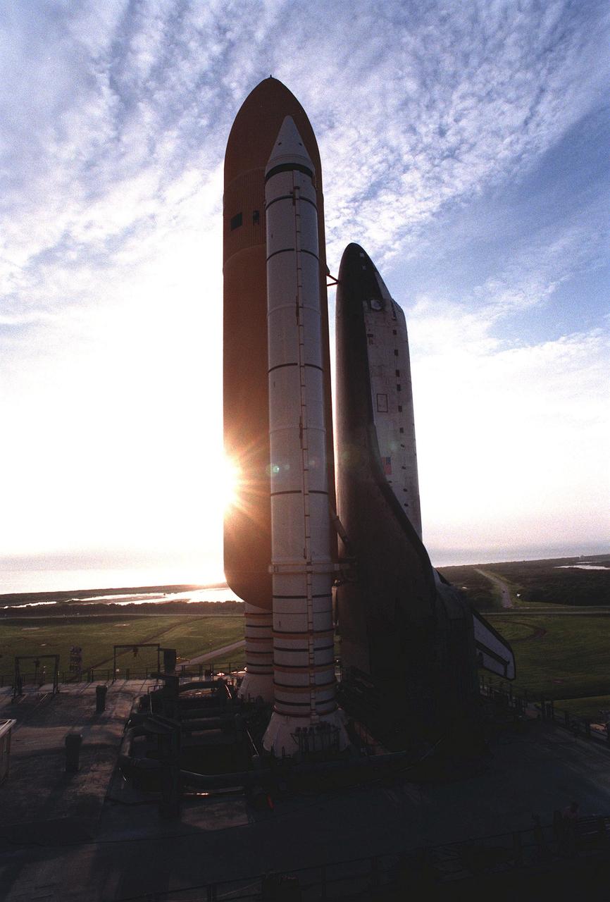 The early morning sun silhouettes STS-95 Space Shuttle Discovery, on the Mobile Launch Platform, at Launch Complex Pad 39B after a 6-hour, 4.2-mile trip from the Vehicle Assembly Building. At the launch pad, the orbiter, external tank and solid rocket boosters will undergo final preparations for the launch, scheduled to lift off Oct. 29. The mission includes research payloads such as the Spartan solar-observing deployable spacecraft, the Hubble Space Telescope Orbital Systems Test Platform, the International Extreme Ultraviolet Hitchhiker, as well as the SPACEHAB single module with experiments on space flight and the aging process