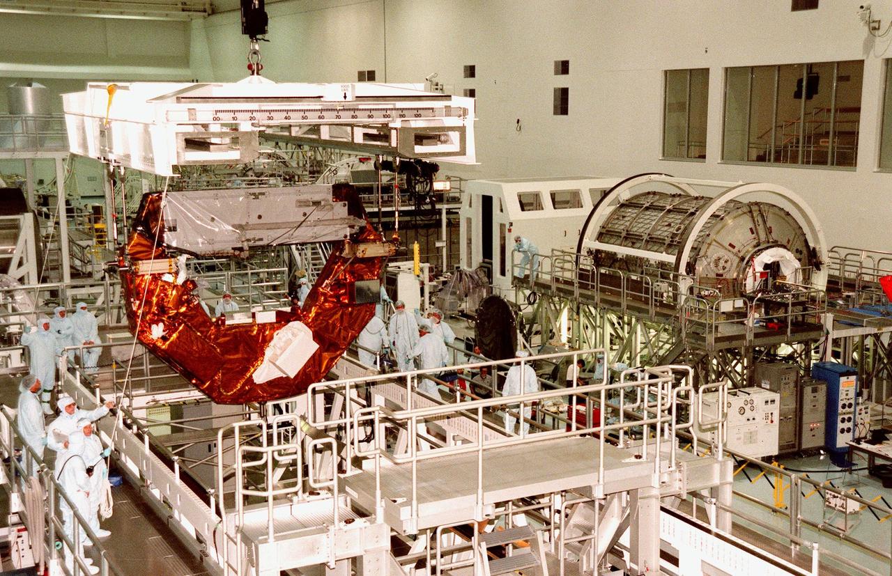 KENNEDY SPACE CENTER, FLA. -- The Hubble Space Telescope Orbiting Systems Test Platform (HOST) is lifted off its work stand in the Space Station Processing Facility before moving it to its payload canister. One of the payloads on the STS-95 mission, the HOST platform is carrying four experiments to validate components planned for installation during the third Hubble Space Telescope servicing mission and to evaluate new technologies in an Earth-orbiting environment. The STS-95 mission is scheduled to launch Oct. 29. It will carry other payloads such as the Spartan solar-observing deployable spacecraft, the International Extreme Ultraviolet Hitchhiker (IEH-3), and the SPACEHAB single module with experiments on space flight and the aging process