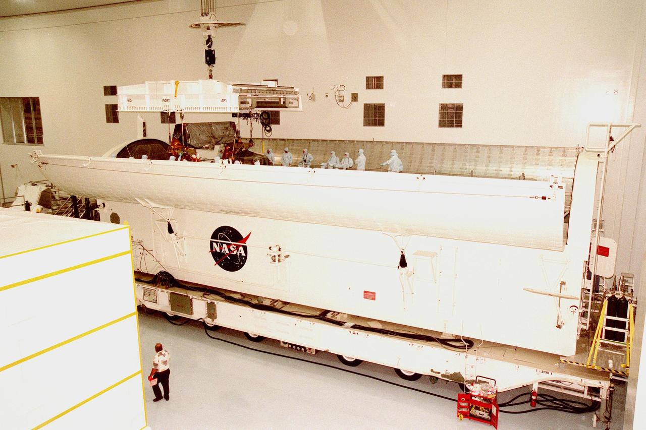 KENNEDY SPACE CENTER, FLA. -- The Hubble Space Telescope Orbiting Systems Test (HOST), one of the payloads on the STS-95 mission, is placed inside its payload canister in the Space Station Processing Facility. The canister is 65 feet long, 18 feet wide and 18 feet, 7 inches high. The HOST platform is carrying four experiments to validate components planned for installation during the third Hubble Space Telescope servicing mission and to evaluate new technologies in an Earth-orbiting environment. The STS-95 mission is scheduled to launch Oct. 29. It will carry other payloads such as the Spartan solar-observing deployable spacecraft, the International Extreme Ultraviolet Hitchhiker (IEH-3), and the SPACEHAB single module with experiments on space flight and the aging process