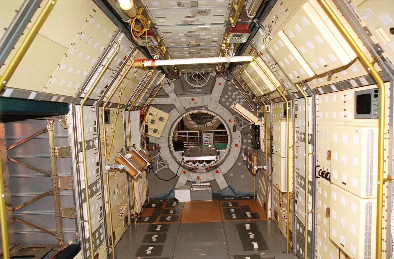 Viewed looking forward, this Spacelab module is empty now, being prepared in the Operations & Checkout Building for shipment to the National Air and Space Museum in Washington, DC. Visible on the floor are the foot restraints used by astronauts to keep them stationary while conducting experiments. Spacelab was designed by the European Space Agency (ESA) for the Space Shuttle program. It first flew on STS-9 in November 1983 and its final flight was the STS-90 Neurolab mission in April 1998. The Spacelab concept of modular experiment racks in a pressurized shirt-sleeve environment made it highly user-friendly and accessible. Numerous experiments conceived by hundreds of scientists on the ground were conducted by flight crews in orbit. Spacelab modules served as on-orbit homes for everything from squirrel monkeys to plant seeds. They supported astronomical as well as Earth observations, for servicing the Hubble Space Telescope and for research preparatory to the International Space Station. One of the greatest benefits afforded by the Spacelab missions was the opportunity to fly a mission more than once, with the second or third flight building on the experiences and data gathered from its predecessors