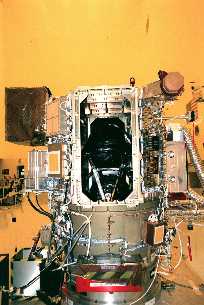 KENNEDY SPACE CENTER, FLA. -- Through the open panel of Deep Space 1 can be seen the rolled-up document (on the left) signed by the workers in the Payload Hazardous Servicing Facility. Deep Space 1 is scheduled to fly on the Boeing Delta 7326 rocket to be launched in October. The first flight in NASA's New Millennium Program, Deep Space 1 is designed to validate 12 new technologies for scientific space missions of the next century. Onboard experiments include an ion propulsion engine and software that tracks celestial bodies so the spacecraft can make its own navigation decisions without the intervention of ground controllers. Deep Space 1 will complete most of its mission objectives within the first two months, but will also do a flyby of a near-Earth asteroid, 1992 KD, in July 1999