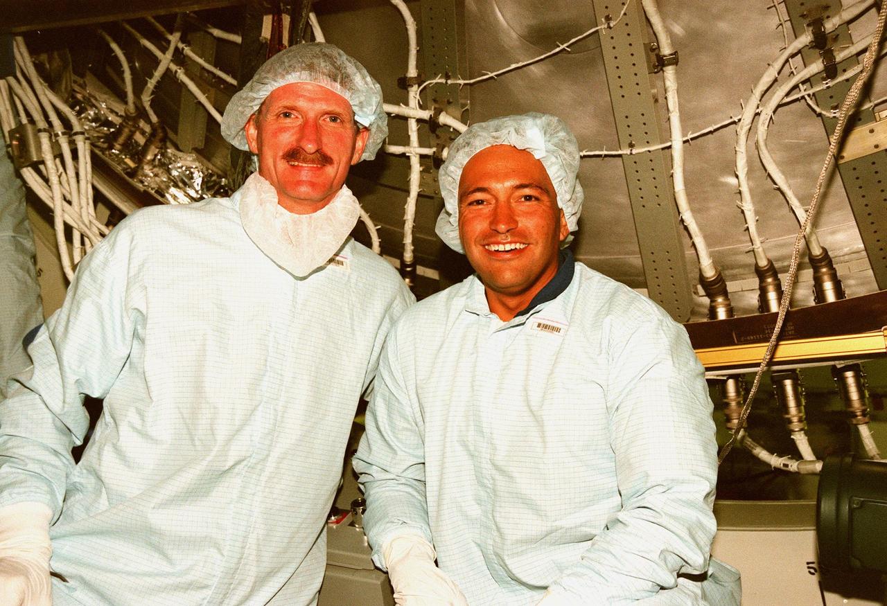 Inside the Space Station Processing Facility, STS-97 Mission Specialists Joseph R. Tanner and Carlos I. Noriega take a break from equipment check for the International Space Station . STS-97, the fourth ISS flight, is targeted to launch on Aug. 5, 1999. It is scheduled to carry integrated truss structure P6, photovoltaic module and radiators