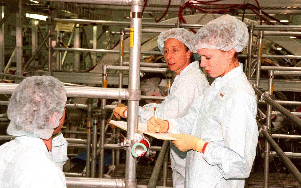 STS-98 Mission Specialist Marsha Ivins (center) checks out equipment for the International Space Station (ISS) with Ursula Stockdale (right), Mod Cargo Operations. STS-98 is scheduled to carry the U.S. laboratory module, the centerpiece ISS, where unprecedented science experiments will be performed in the near zero gravity of space. The launch is targeted for October 1999 aboard the Space Shuttle Endeavour