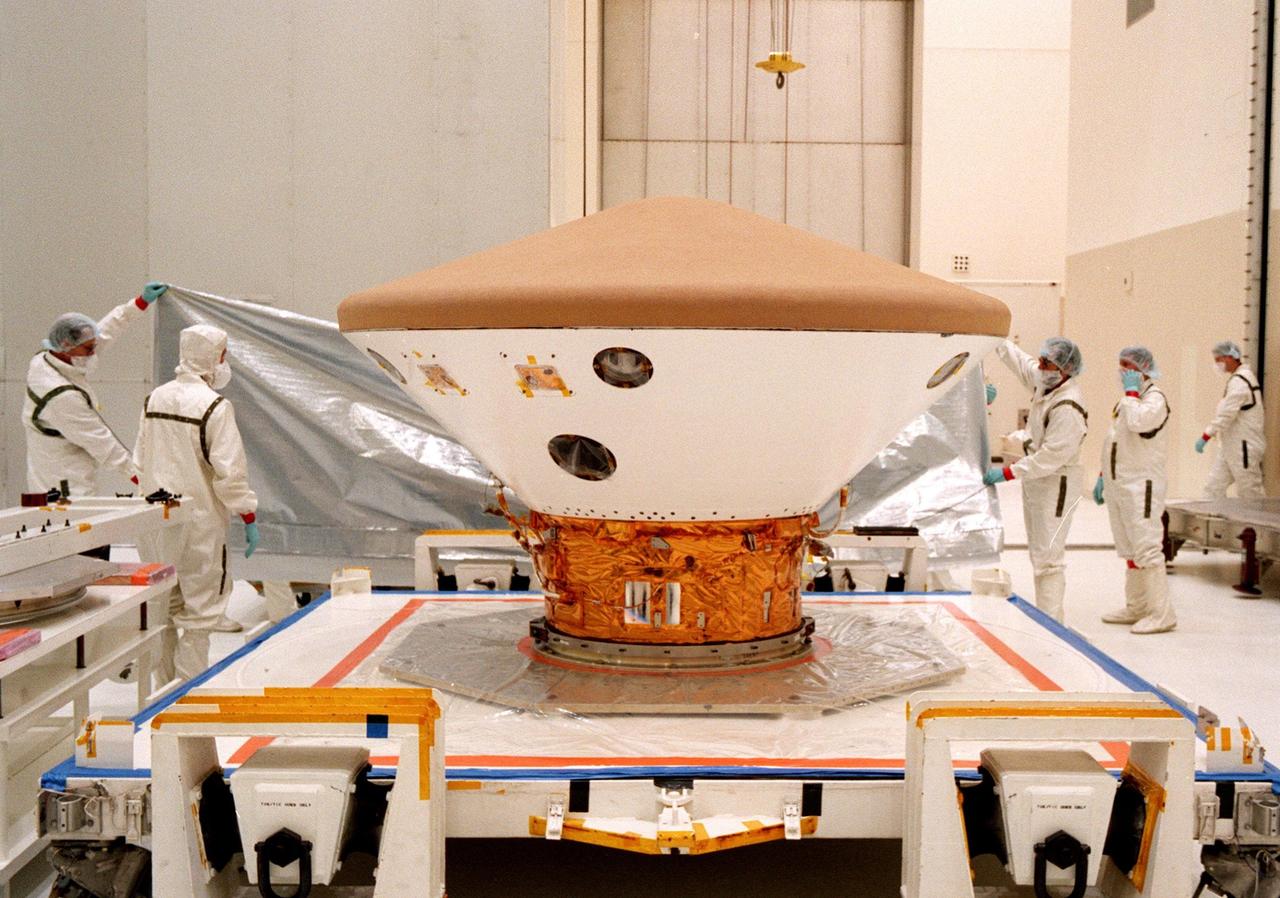 KENNEDY SPACE CENTER, FLA. -- In the Spacecraft Assembly and Encapsulation Facility-2 (SAEF-2), the protective covering for the Mars Polar Lander is removed so technicians can prepare the Lander for testing, which includes a functional test of the science instruments and the basic spacecraft subsystems. The Mars Polar Lander is targeted for launch from Cape Canaveral Air Station aboard a Delta II rocket on Jan. 3, 1999. The solar-powered spacecraft is designed to touch down on the Martian surface near the northern-most boundary of the south pole in order to study the water cycle there. The lander also will help scientists learn more about climate change and current resources on Mars, studying such things as frost, dust, water vapor and condensates in the Martian atmosphere