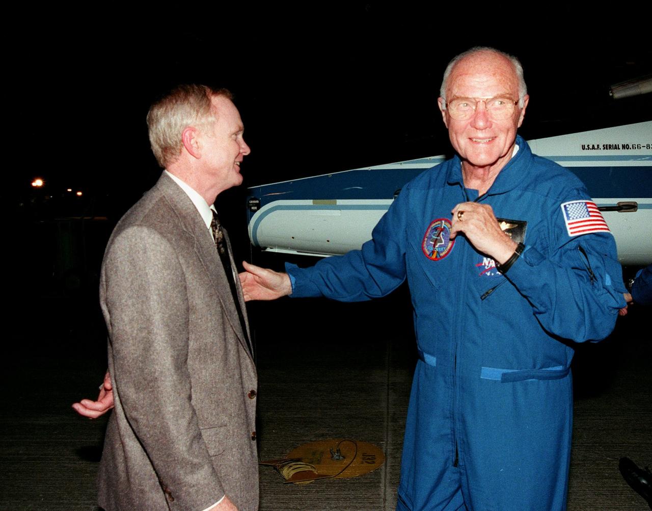 Center Director Roy Bridges (left) greets STS-95 Payload Specialist John H. Glenn Jr. after his arrival on a T-38 jet aircraft at the Shuttle Landing Facility at KSC. Glenn, a senator from Ohio, and the rest of the crew are at KSC to participate in a Terminal Countdown Demonstration Test (TCDT). The TCDT includes mission familiarization activities, training in emergency exit from the orbiter and launch pad, and a simulated main engine cut-off exercise. The other crew members on the mission are Mission Commander Curtis L. Brown; Pilot Steven W. Lindsey; Mission Specialists Scott E. Parazynski, Stephen K. Robinson, and Pedro Duque of Spain, representing the European Space Agency (ESA); and Payload Specialist Chiaki Mukai, representing the National Space Development Agency of Japan (NASDA). The STS-95 mission includes research payloads such as the Spartan solar-observing deployable spacecraft, the Hubble Space Telescope Orbital Systems Test Platform, the International Extreme Ultraviolet Hitchhiker, as well as the SPACEHAB single module with experiments on space flight and the aging process