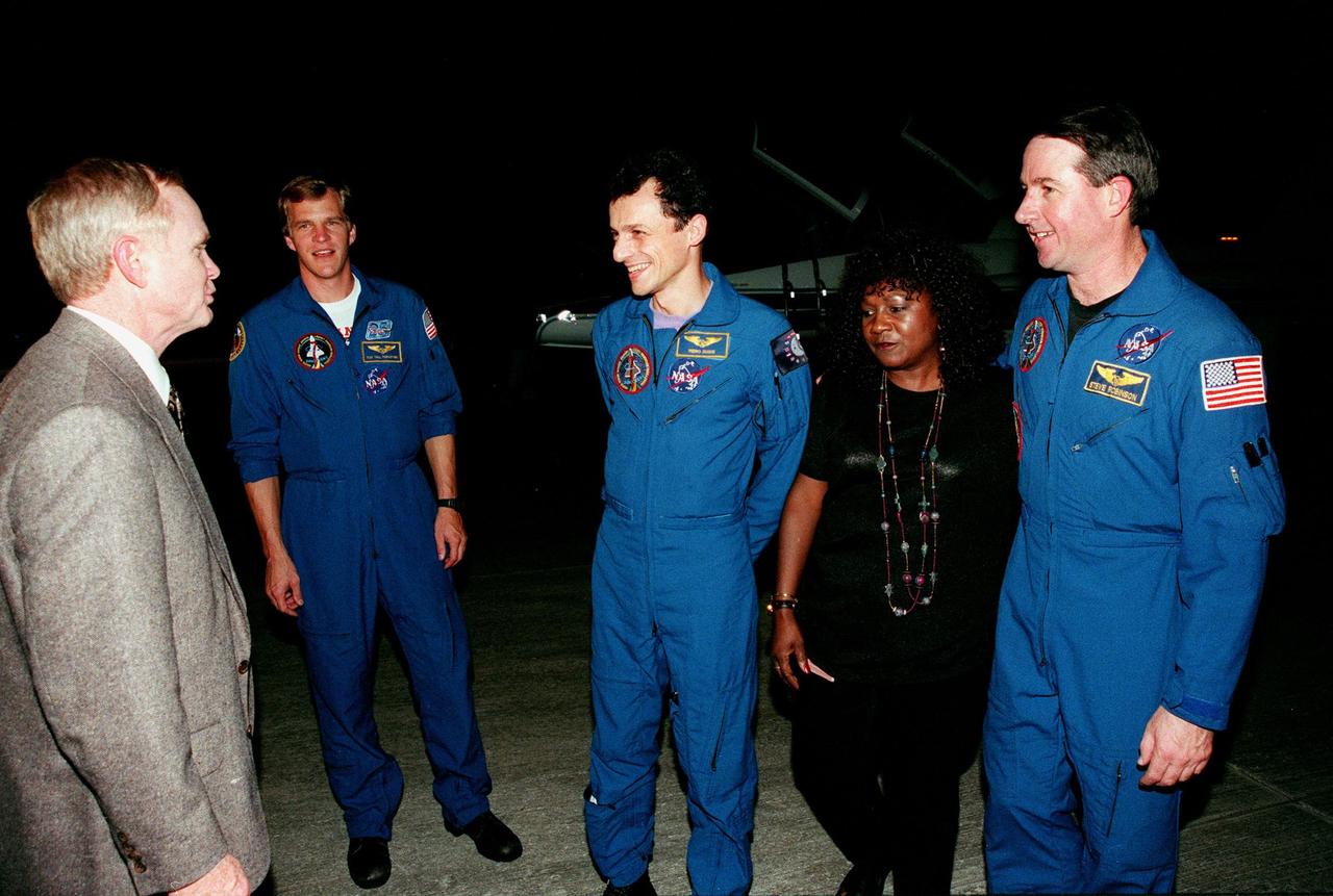 (Left to right) Center Director Roy Bridges welcomes STS-95 Mission Specialists Scott E. Parazynski, Pedro Duque of Spain, representing the European Space Agency (ESA), and Stephen K. Robinson (far right) after their arrival aboard T-38 jet aircraft at the Shuttle Landing Facility at KSC. Standing between Duque and Robinson is Dolores Green, NASA. The STS-95 crew are at KSC to participate in a Terminal Countdown Demonstration Test (TCDT). The TCDT includes mission familiarization activities, training in emergency exit from the orbiter and launch pad, and a simulated main engine cut-off exercise. The other members on the mission are Mission Commander Curtis L. Brown, Pilot Steven W. Lindsey; and Payload Specialists Chiaki Mukai, representing the National Space Development Agency of Japan (NASDA), and John H. Glenn Jr., senator from Ohio. The STS-95 mission, scheduled for liftoff on Oct. 29, includes research payloads such as the Spartan solar-observing deployable spacecraft, the Hubble Space Telescope Orbital Systems Test Platform, the International Extreme Ultraviolet Hitchhiker, as well as the SPACEHAB single module with experiments on space flight and the aging process