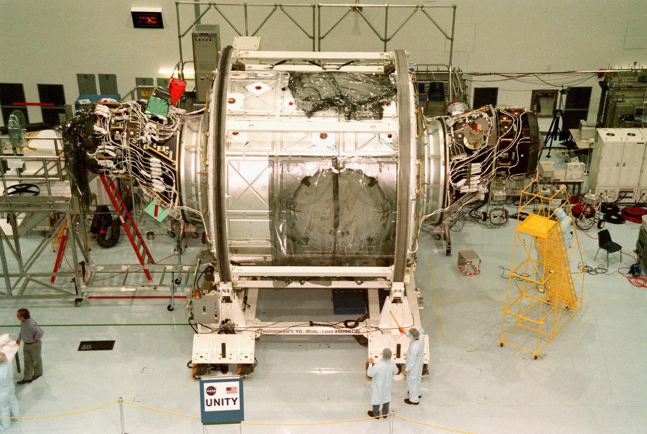 In the Space Station Processing Facility, the Unity connecting module, part of the International Space Station, is shown with Pressurized Mating Adapters 1 (left) and 2 (right) attached. Unity is scheduled to undergo testing of the common berthing mechanism to which other space station elements will dock. Unity is the primary payload on mission STS-88, targeted to launch Dec. 3, 1998. Other testing includes the Pad Demonstration Test to verify the compatibility of the module with the Space Shuttle as well as the ability of the astronauts to send and receive commands to Unity from the flight deck of the orbiter. Unity is expected to be ready for installation into the payload canister on Oct. 25, and transported to Launch Pad 39-A on Oct. 27. The Unity will be mated to the Russian-built Zarya control module which should already be in orbit at that time