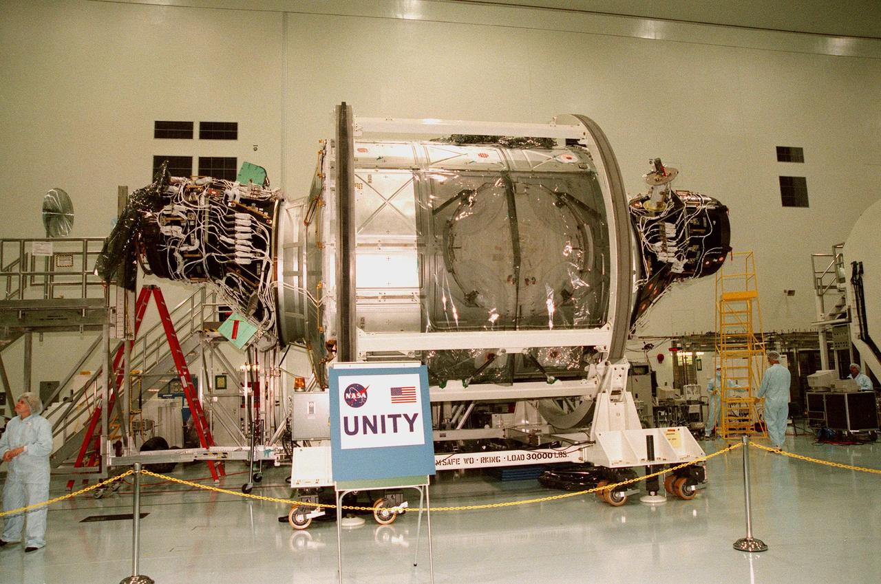 In the Space Station Processing Facility, the Unity connecting module, part of the International Space Station, is shown with Pressurized Mating Adapters 1 (left) and 2 (right) attached. Unity is scheduled to undergo testing of the common berthing mechanism to which other space station elements will dock. Unity is the primary payload on mission STS-88, targeted to launch Dec. 3, 1998. Other testing includes the Pad Demonstration Test to verify the compatibility of the module with the Space Shuttle as well as the ability of the astronauts to send and receive commands to Unity from the flight deck of the orbiter. Unity is expected to be ready for installation into the payload canister on Oct. 25, and transported to Launch Pad 39-A on Oct. 27. The Unity will be mated to the Russian-built Zarya control module which should already be in orbit at that time