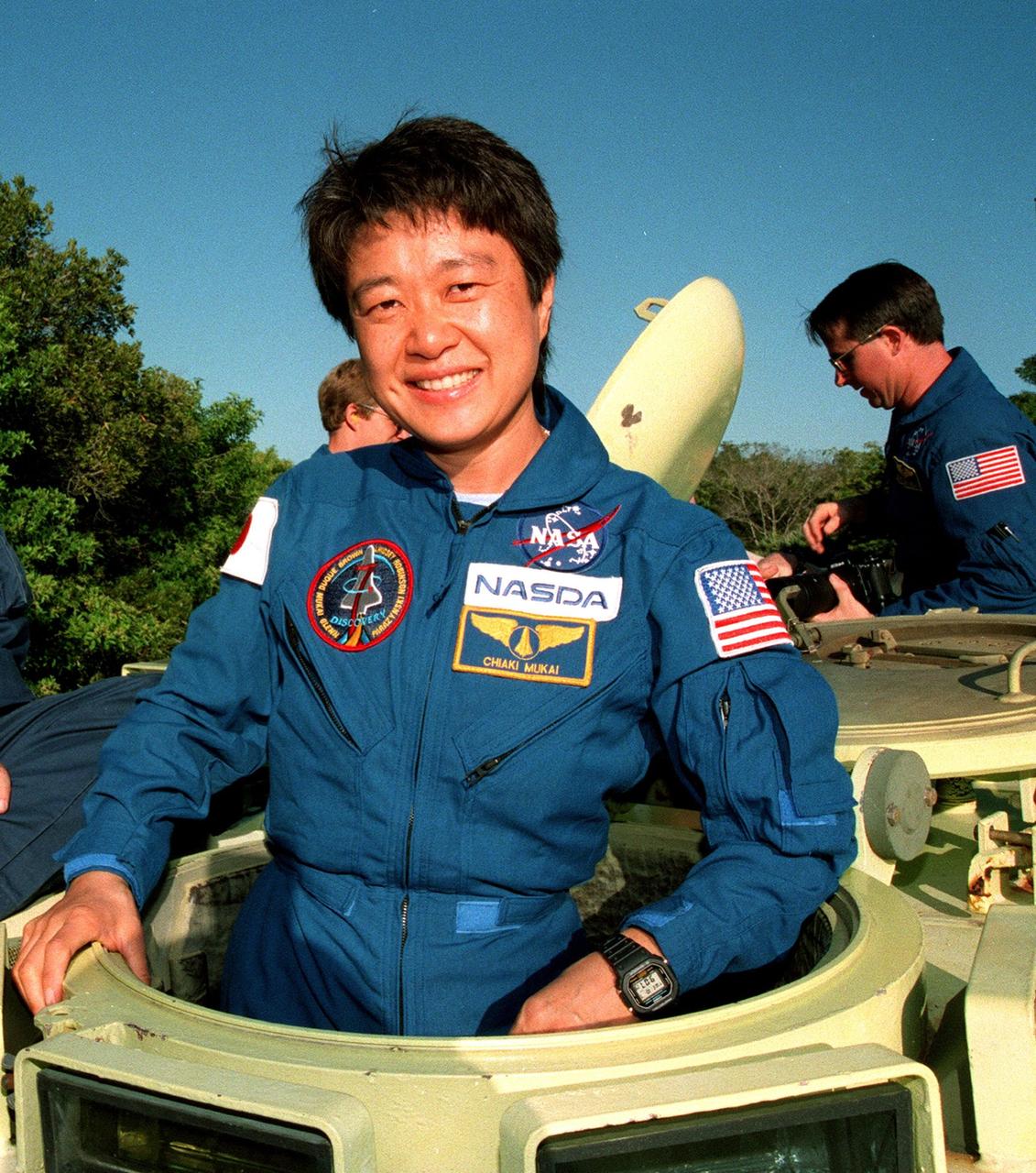 Near Launch Pad 39-B, STS-95 Payload Specialist Chiaki Mukai, representing the National Space Development Agency of Japan (NASDA), climbs into an M-113, a small armored personnel carrier, that is part of emergency egress training. The tracked vehicle could be used by the crew in the event of an emergency at the pad during which the crew must make a quick exit from the area. The STS-95 crew is at KSC to participate in a Test Countdown Demonstration Test (TCDT) which also includes mission familiarization activities and a simulated main engine cut-off exercise. The other members on the mission are Mission Commander Curtis L. Brown, Pilot Steven W. Lindsey, Mission Specialists Scott E. Parazynski, Stephen K. Robinson, and Pedro Duque of Spain, representing the European Space Agency (ESA); and Payload Specialist John H. Glenn Jr., senator from Ohio. The STS-95 mission, targeted for liftoff on Oct. 29, includes research payloads such as the Spartan solar-observing deployable spacecraft, the Hubble Space Telescope Orbital Systems Test Platform, the International Extreme Ultraviolet Hitchhiker, as well as the SPACEHAB single module with experiments on space flight and the aging process
