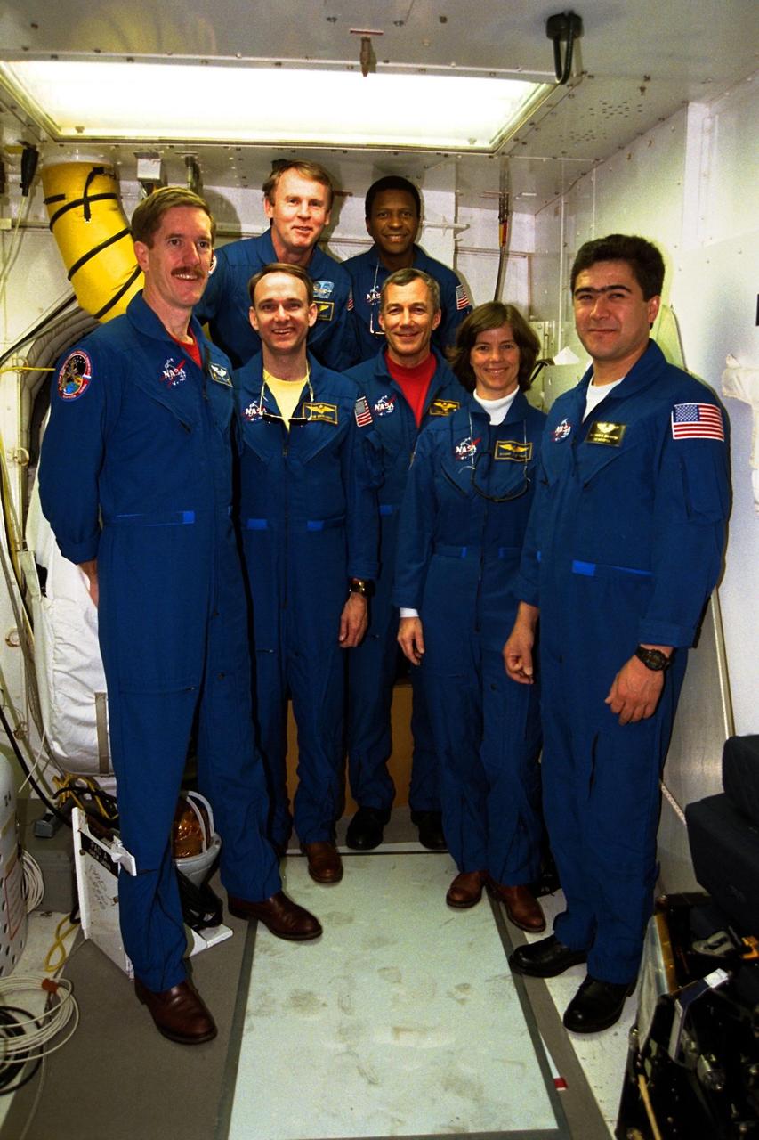 The STS-89 crew pose in the white room at the entrance to the Space Shuttle Endeavour at KSC’s Launch Pad 39A during Terminal Countdown Demonstration Test (TCDT) activities. The crew include, from left to right, Mission Specialist James Reilly, Ph.D.; Pilot Joe Edwards Jr.; Commander Terrence Wilcutt; Mission Specialists Bonnie Dunbar, Ph.D., and Salizhan Sharipov of the Russian Space Agency. In back are, from left to right, Mission Specialists Andrew Thomas, Ph.D., and Michael Anderson. The TCDT is held at KSC prior to each Space Shuttle flight to provide crews with an opportunity to participate in simulated countdown activities. The STS-89 mission will be the eighth docking of the Space Shuttle with the Russian Space Station Mir. After docking, Mission Specialist Andrew Thomas, Ph.D., will transfer to the space station, succeeding David Wolf, M.D., who will return to Earth aboard Endeavour. Dr. Thomas will live and work on Mir until June. STS-89 is scheduled for a Jan. 22 liftoff at 9:48 p.m