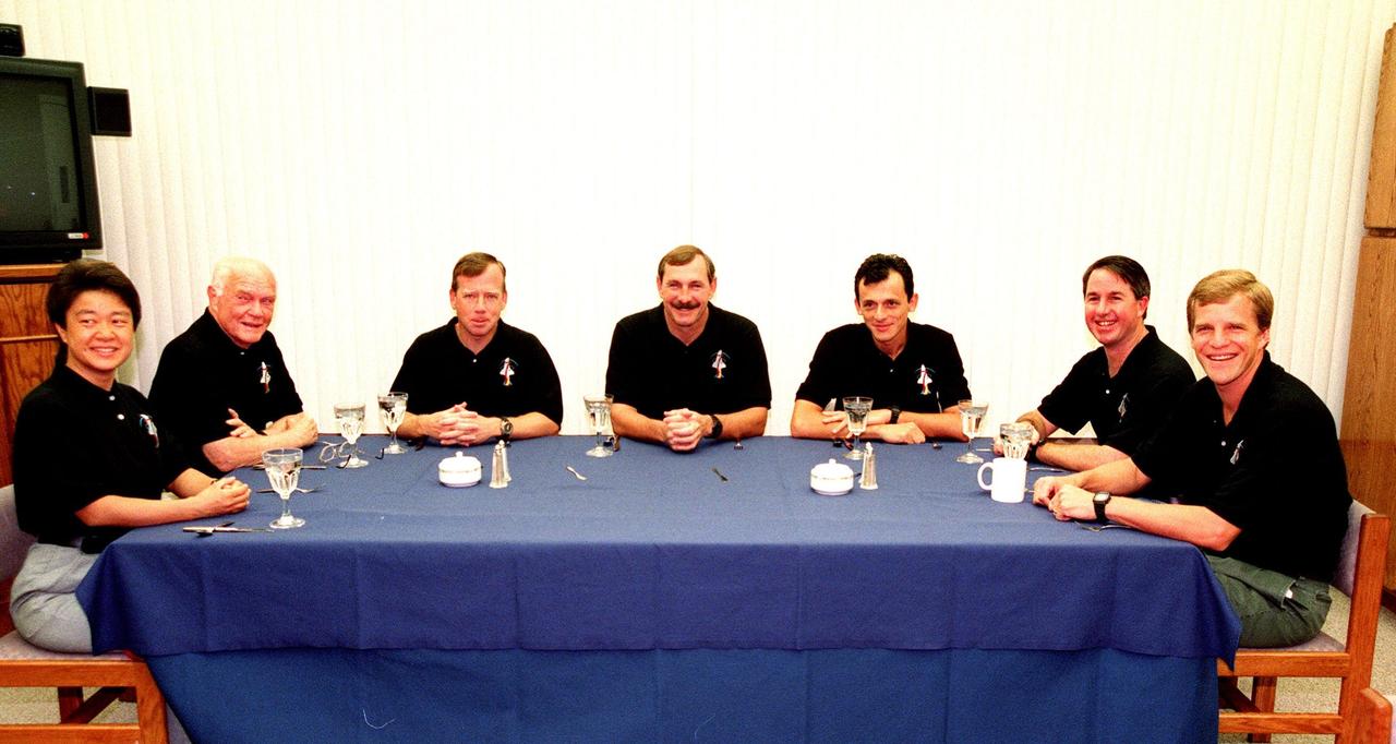The STS-95 crew partakes in the traditional breakfast in the crew quarters at the Operations and Checkout (O&C) Building prior to their suitup for their trip to Launch Pad 39-B. Seated (left to right) are Payload Specialist Chiaki Mukai (M.D., Ph.D.), representing the National Space Development Agency of Japan (NASDA), Payload Specialist John H. Glenn Jr., senator from Ohio, Pilot Steven W. Lindsey, Mission Commander Curtis L. Brown, Mission Specialist Pedro Duque of Spain, representing the European Space Agency (ESA), Mission Specialist Stephen K. Robinson, and Mission Specialist Scott E. Parazynski. The STS-95 crew are at KSC to participate in the Terminal Countdown Demonstration Test (TCDT) which includes mission familiarization activities, emergency egress training, and a simulated main engine cutoff. The STS-95 mission, targeted for liftoff on Oct. 29, includes research payloads such as the Spartan solar-observing deployable spacecraft, the Hubble Space Telescope Orbital Systems Test Platform, the International Extreme Ultraviolet Hitchhiker, as well as the SPACEHAB single module with experiments on space flight and the aging process. Following the TCDT, the crew will be returning to Houston for final flight preparations