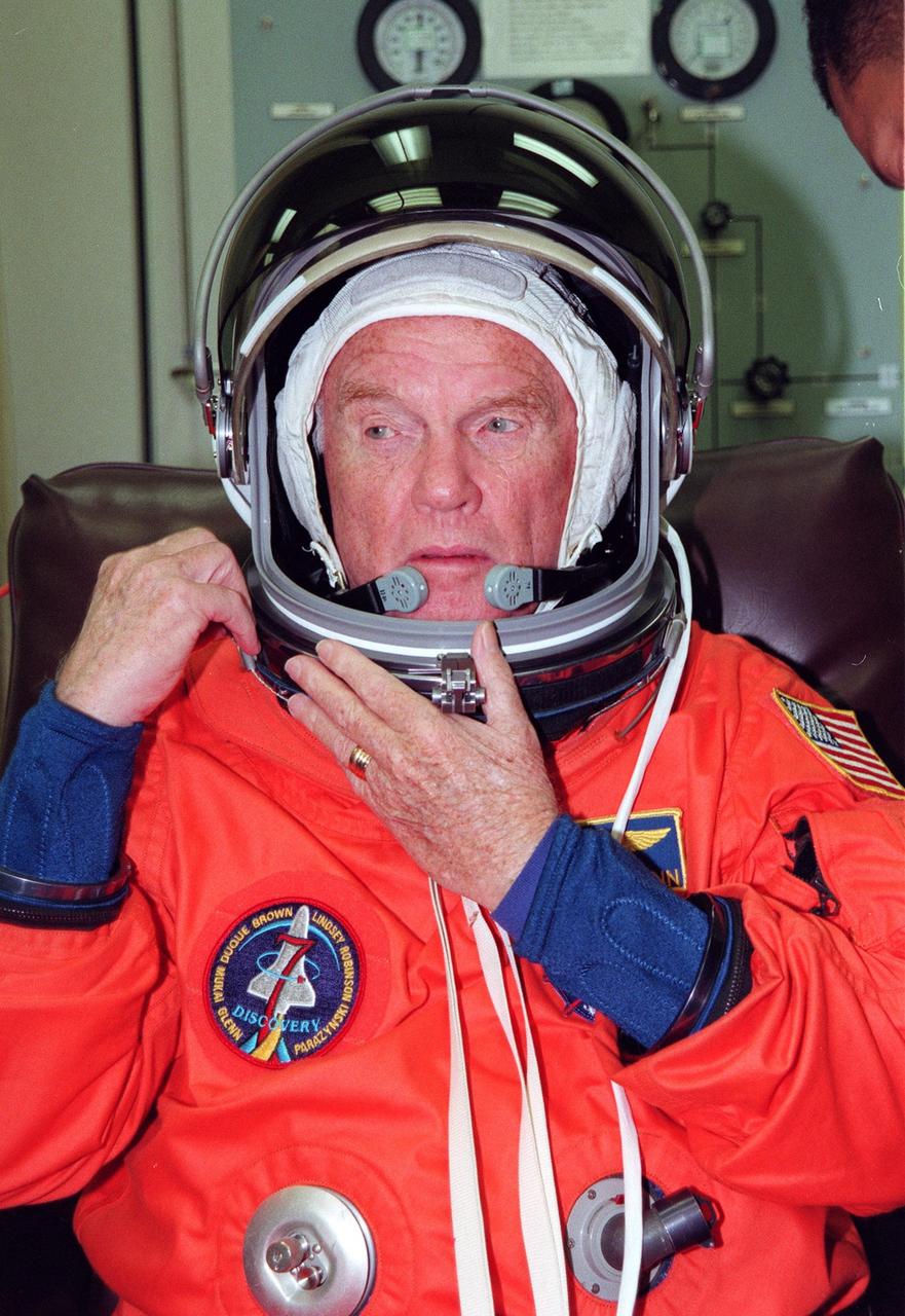 STS-95 Payload Specialist John H. Glenn Jr., a senator from Ohio and one of the original seven Project Mercury astronauts, suits up in the Operations and Checkout (O&C) Building prior to his trip to Launch Pad 39-B. Glenn and the rest of the STS-95 crew are at KSC to participate in the Terminal Countdown Demonstration Test (TCDT) which includes mission familiarization activities, emergency egress training, and a simulated main engine cutoff. The other crew members are Payload Specialist Chiaki Mukai (M.D., Ph.D.), representing the National Space Development Agency of Japan (NASDA), Pilot Steven W. Lindsey, Mission Specialist Scott E. Parazynski, Mission Specialist Stephen K. Robinson, Mission Specialist Pedro Duque of Spain, representing the European Space Agency (ESA), and Mission Commander Curtis L. Brown. The STS-95 mission, targeted for liftoff on Oct. 29, includes research payloads such as the Spartan solar-observing deployable spacecraft, the Hubble Space Telescope Orbital Systems Test Platform, the International Extreme Ultraviolet Hitchhiker, as well as the SPACEHAB single module with experiments on space flight and the aging process. Following the TCDT, the crew will be returning to Houston for final flight preparations