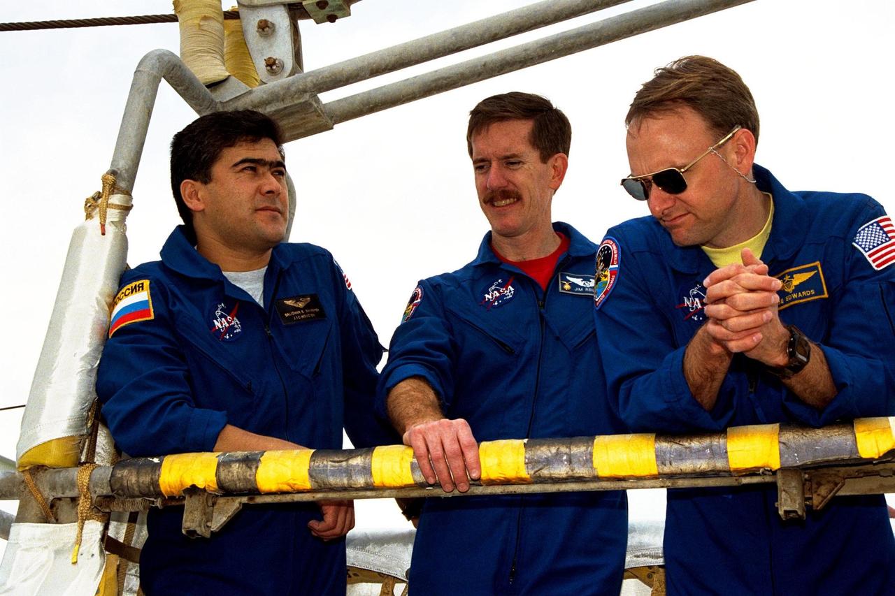 KENNEDY SPACE CENTER, Fla. -- Standing in a slidewire basket at KSC’s Launch Pad 39A are, left to right, STS-89 Mission Specialists Salizhan Sharipov of the Russian Space Agency and James Reilly, Ph.D., with Pilot Joe Edwards Jr. The seven astronauts assigned to the eighth Shuttle-Mir docking flight are completing Terminal Countdown Demonstration Test (TCDT) activities. A dress rehearsal for launch, the TCDT includes emergency egress training at the launch pad and culminates with a simulated countdown. STS-89 Mission Specialist Andrew Thomas, Ph.D, will transfer to the Russian Space Station Mir and succeed David Wolf, M.D., who will return to Earth aboard Endeavour. The Space Shuttle Endeavour is undergoing preparations for liftoff, scheduled for Jan. 22. Dr. Thomas will live and work on Mir until June