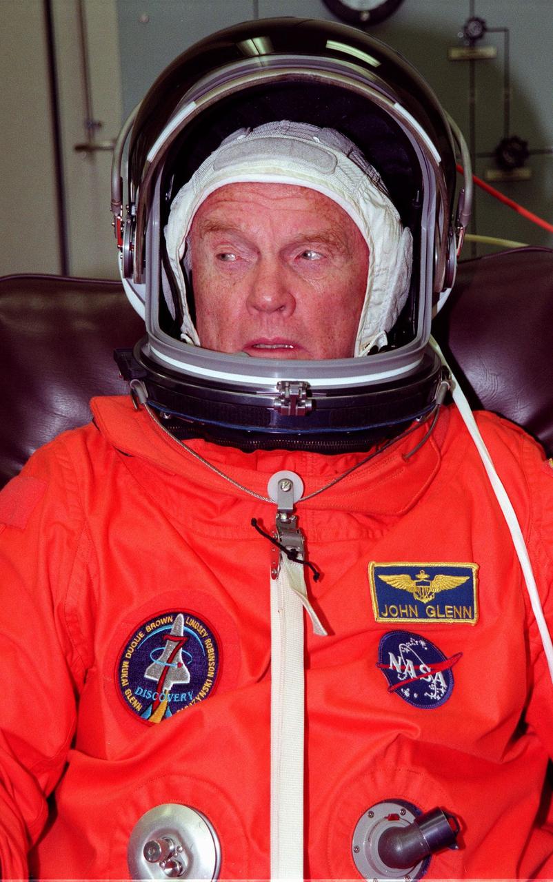 STS-95 Payload Specialist John H. Glenn Jr., a senator from Ohio and one of the original seven Project Mercury astronauts, suits up in the Operations and Checkout (O&C) Building prior to his trip to Launch Pad 39-B. Glenn and the rest of the STS-95 crew are at KSC to participate in the Terminal Countdown Demonstration Test (TCDT) which includes mission familiarization activities, emergency egress training, and a simulated main engine cutoff. The other crew members are Payload Specialist Chiaki Mukai (M.D., Ph.D.), representing the National Space Development Agency of Japan (NASDA), Pilot Steven W. Lindsey, Mission Specialist Scott E. Parazynski, Mission Specialist Stephen K. Robinson, Mission Specialist Pedro Duque of Spain, representing the European Space Agency (ESA), and Mission Commander Curtis L. Brown. The STS-95 mission, targeted for liftoff on Oct. 29, includes research payloads such as the Spartan solar-observing deployable spacecraft, the Hubble Space Telescope Orbital Systems Test Platform, the International Extreme Ultraviolet Hitchhiker, as well as the SPACEHAB single module with experiments on space flight and the aging process. Following the TCDT, the crew will be returning to Houston for final flight preparations