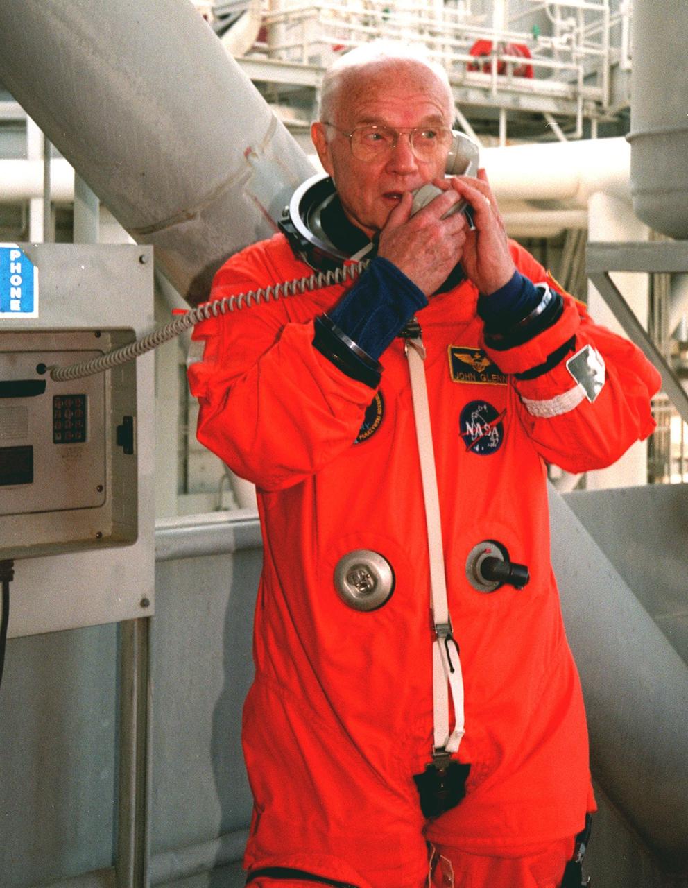 STS-95 Payload Specialist John H. Glenn Jr., senator from Ohio, takes a break to make a phone call on the 195-foot level of Launch Pad 39B before a pre-launch countdown exercise. Glenn and other crew members are at KSC to participate in the Terminal Countdown Demonstration Test (TCDT) which includes mission familiarization activities, emergency egress training, and a simulated main engine cutoff. The other crew members are Payload Specialist Chiaki Mukai (M.D., Ph.D.), representing the National Space Development Agency of Japan (NASDA), Pilot Steven W. Lindsey, Mission Specialist Scott E. Parazynski, Mission Specialist Stephen K. Robinson, Mission Specialist Pedro Duque of Spain, representing the European Space Agency (ESA), and Mission Commander Curtis L. Brown. The STS-95 mission, targeted for liftoff on Oct. 29, includes research payloads such as the Spartan solar-observing deployable spacecraft, the Hubble Space Telescope Orbital Systems Test Platform, the International Extreme Ultraviolet Hitchhiker, as well as the SPACEHAB single module with experiments on space flight and the aging process. Following the TCDT, the crew will be returning to Houston for final flight preparations