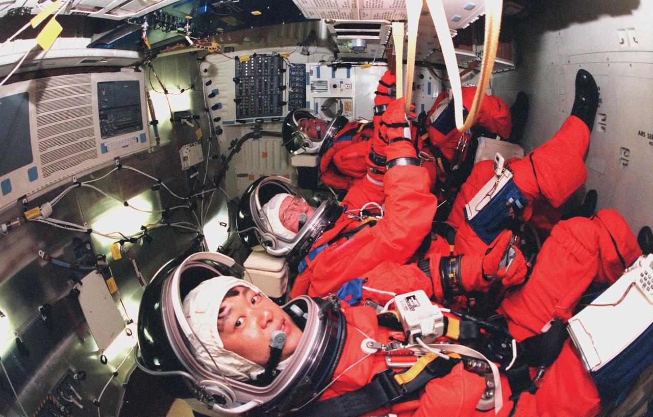 In their flight seats aboard Space Shuttle Discovery are (front to back) STS-95 Payload Specialists Chiaki Mukai (M.D., Ph.D.), representing the National Space Development Agency of Japan (NASDA), and John H. Glenn Jr., senator from Ohio, and Mission Specialist Stephen K. Robinson. Mukai, Glenn and Robinson, along with other crew members are at KSC to participate in the Terminal Countdown Demonstration Test (TCDT) which includes mission familiarization activities, emergency egress training, and a simulated main engine cutoff. Not shown are Pilot Steven W. Lindsey, Mission Specialist Scott E. Parazynski, Mission Specialist Pedro Duque of Spain, representing the European Space Agency (ESA), and Mission Commander Curtis L. Brown. The STS-95 mission, targeted for liftoff on Oct. 29, includes research payloads such as the Spartan solar-observing deployable spacecraft, the Hubble Space Telescope Orbital Systems Test Platform, the International Extreme Ultraviolet Hitchhiker, as well as the SPACEHAB single module with experiments on space flight and the aging process. Following the TCDT, the crew will be returning to Houston for final flight preparations