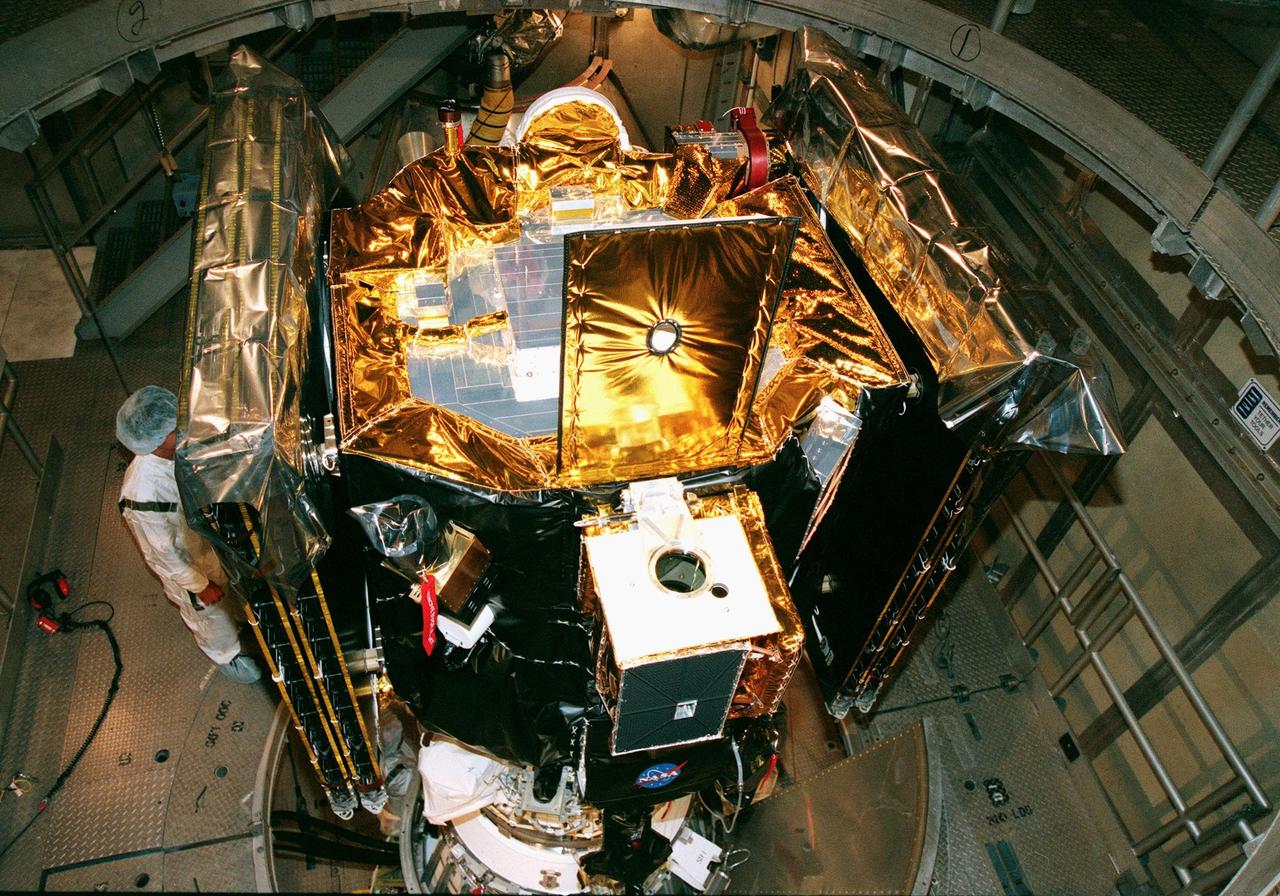 KENNEDY SPACE CENTER, FLA. -- On Launch Pad 17A at Cape Canaveral Air Station, Deep Space 1 is viewed from above after installation on a Boeing Delta 7326 rocket . Targeted for launch on Oct. 25, Deep Space 1 is the first flight in NASA's New Millennium Program, and is designed to validate 12 new technologies for scientific space missions of the next century, including the engine. Propelled by the gas xenon, the engine is being flight-tested for future deep space and Earth-orbiting missions. Deceptively powerful, the ion drive emits only an eerie blue glow as ionized atoms of xenon are pushed out of the engine. While slow to pick up speed, over the long haul it can deliver 10 times as much thrust per pound of fuel as liquid or solid fuel rockets. Other onboard experiments include software that tracks celestial bodies so the spacecraft can make its own navigation decisions without the intervention of ground controllers. Deep Space 1 will complete most of its mission objectives within the first two months, but will also do a flyby of a near-Earth asteroid, 1992 KD, in July 1999