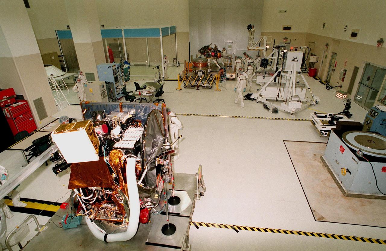 In the Spacecraft Assembly and Encapsulation Facility-2 (SAEF-2), the Mars Climate Orbiter (foreground) and the Mars Polar Lander are on display for the media. The scheduled launch date for the Mars Climate Orbiter is Dec. 10, 1998, aboard a Boeing Delta II rocket. It is heading for Mars where it will primarily support its companion Mars Polar Lander spacecraft, planned for launch on Jan. 3, 1999. After that, the Mars Climate Orbiter's instruments will monitor the Martian atmosphere and image the planet's surface on a daily basis for one Martian year (two Earth years). It will observe the appearance and movement of atmospheric dust and water vapor, as well as characterize seasonal changes on the surface. The detailed images of the surface features will provide important clues to the planet's early climate history and give scientists more information about possible liquid water reserves beneath the surface