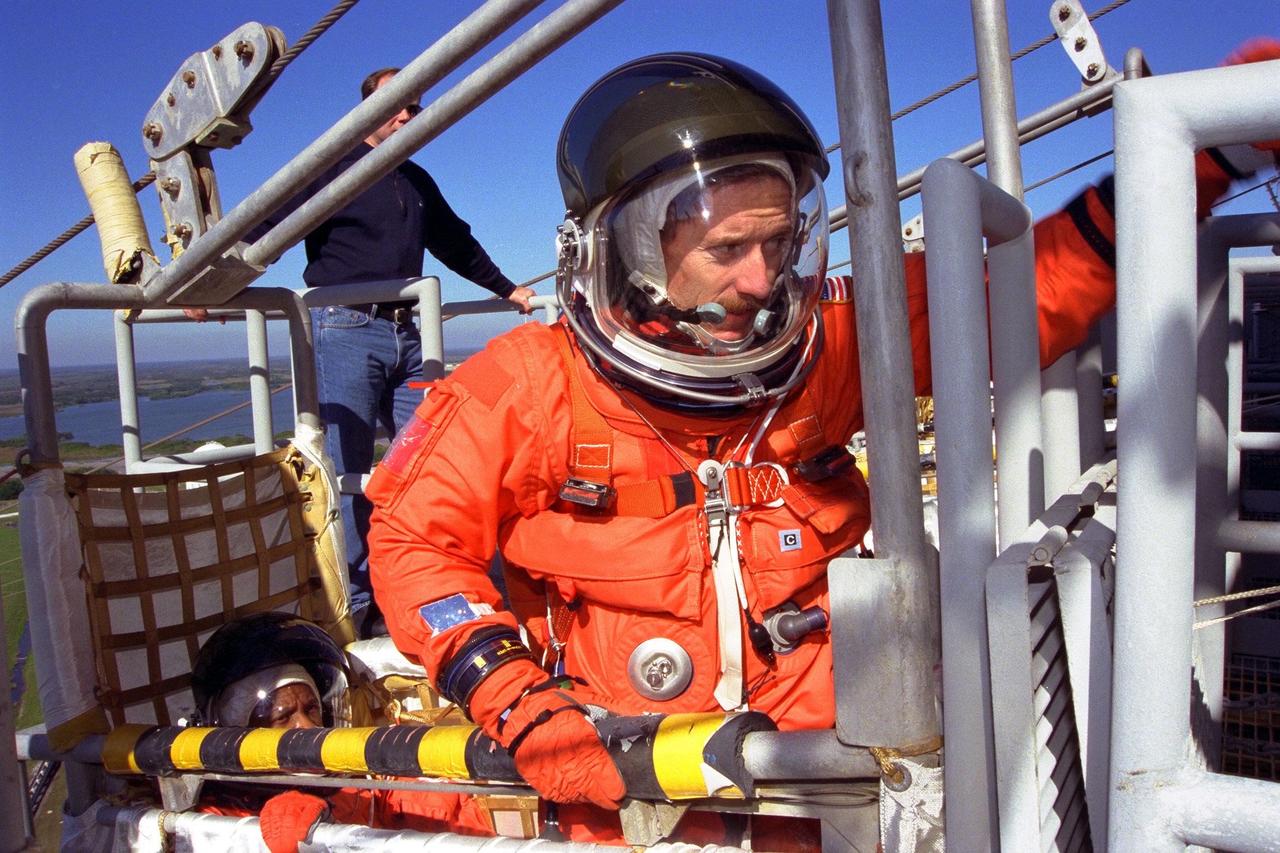 KENNEDY SPACE CENTER, Fla. -- Standing in a slidewire basket at KSC’s Launch Pad 39A is STS-89 Mission Specialist James Reilly, Ph.D. The seven astronauts of STS-89 assigned to the eighth Shuttle-Mir docking flight are completing Terminal Countdown Demonstration Test (TCDT) activities at Kennedy Space Center. A dress rehearsal for launch, the TCDT includes emergency egress training at the launch pad and culminates with a simulated countdown. STS-89 Mission Specialist Andrew Thomas, Ph.D, will transfer to the Russian Space Station Mir and succeed David Wolf, M.D., who will return to Earth aboard Endeavour. The Space Shuttle Endeavour is undergoing preparations for liftoff, scheduled for Jan. 22. Dr. Thomas will live and work on Mir until June