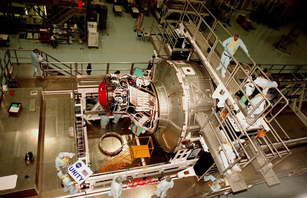 In the Space Station Processing Facility, workers make a final check of the nameplate to be attached to the Unity connecting module, part of the International Space Station. Unity was expected to be transported to Launch Pad 39A on Oct. 26 for launch aboard Space Shuttle Endeavour on Mission STS-88 in December. The Unity is a connecting passageway to the living and working areas of ISS. While on orbit, the flight crew will deploy Unity from the payload bay and attach Unity to the Russian-built Zarya control module which will be in orbit at that time