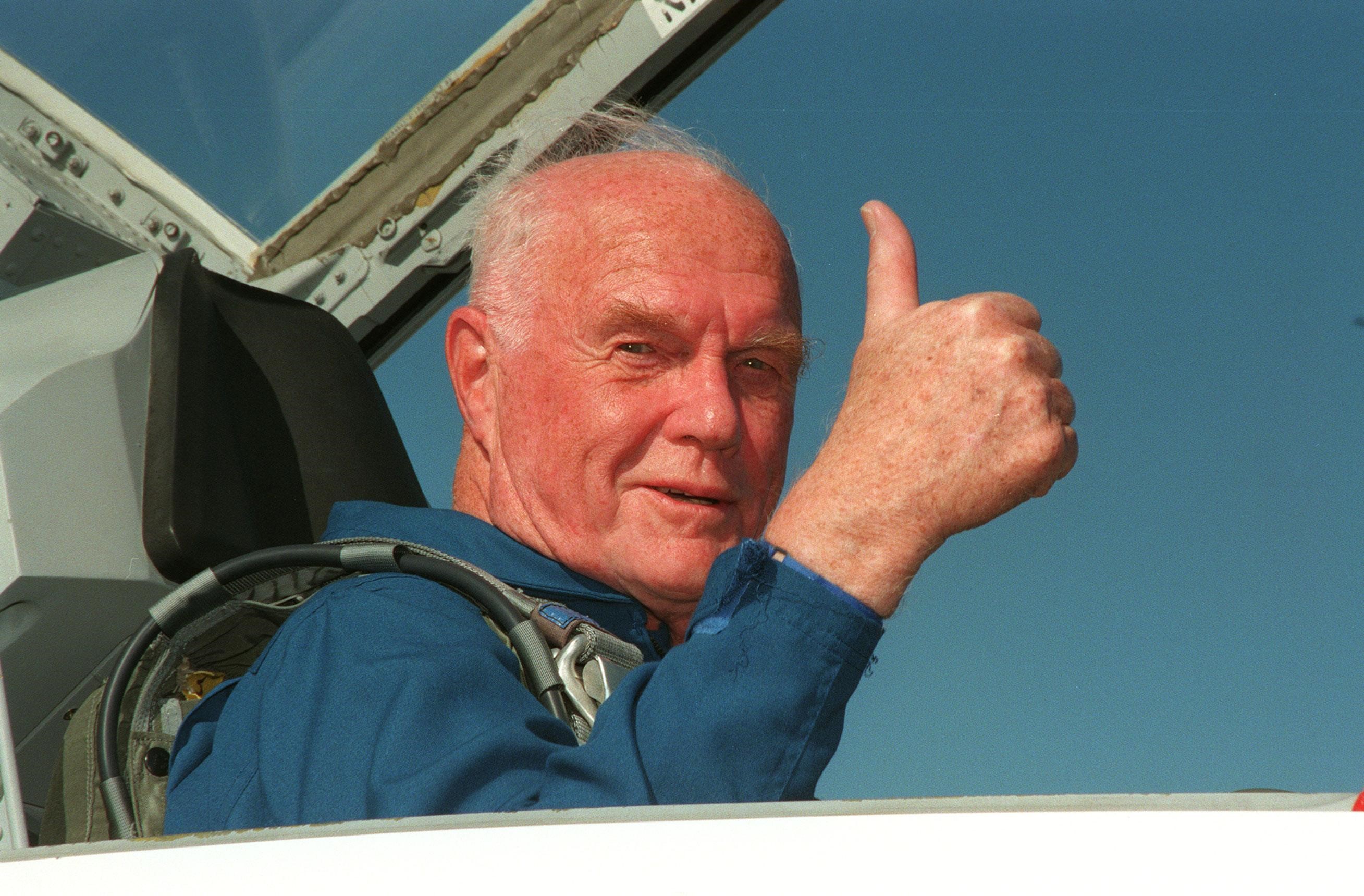 John Glenn in cockpit of T-38 giving a thumbs up